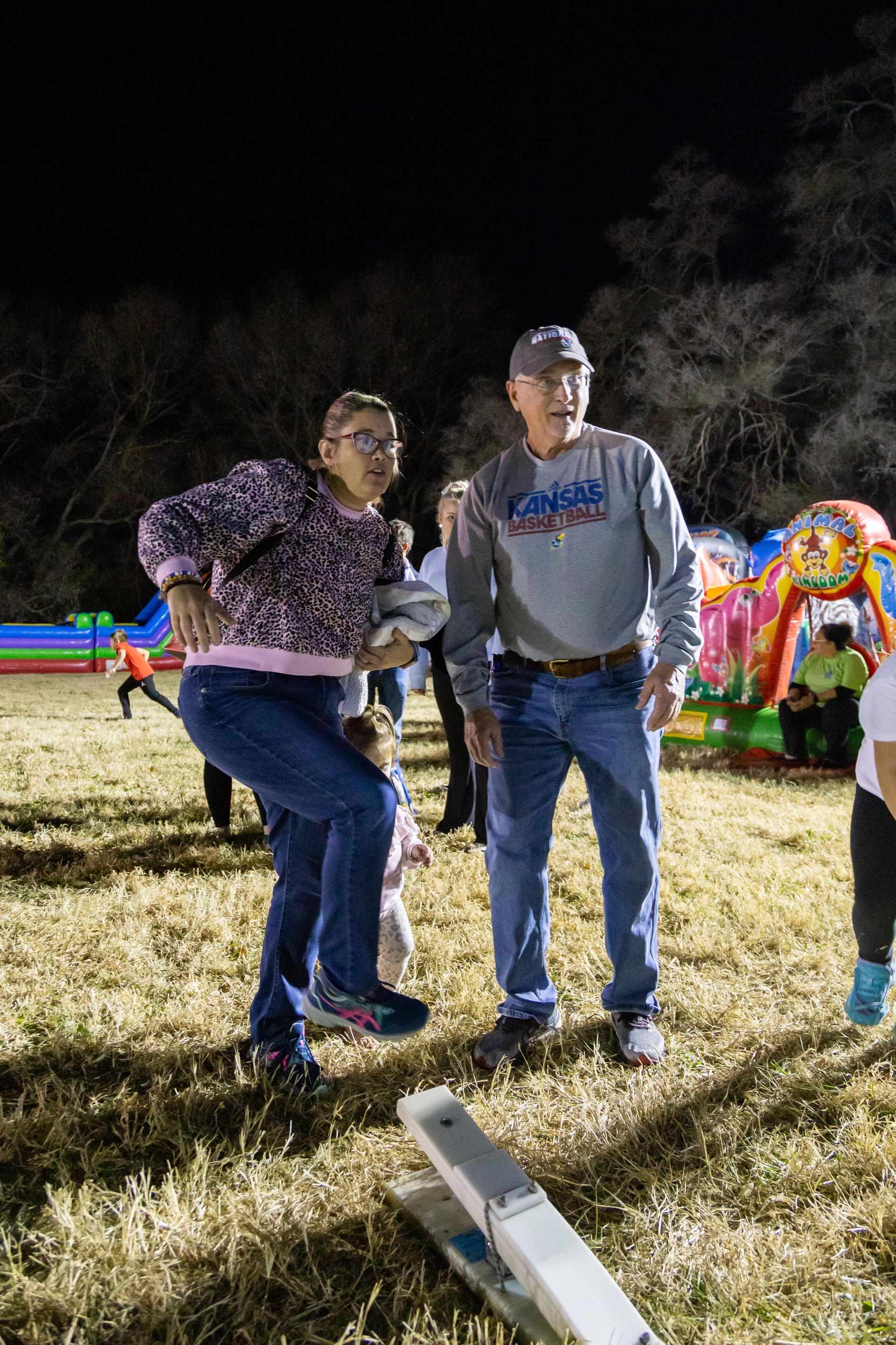 People stand around and laugh at ICL's fall family picnic.