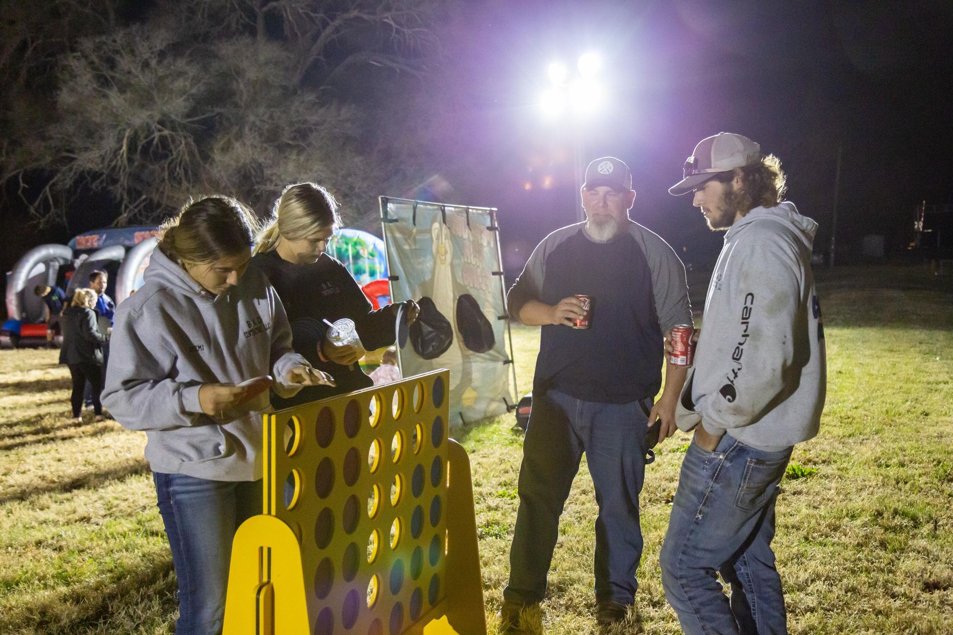 People stand around and laugh at ICL's fall family picnic.