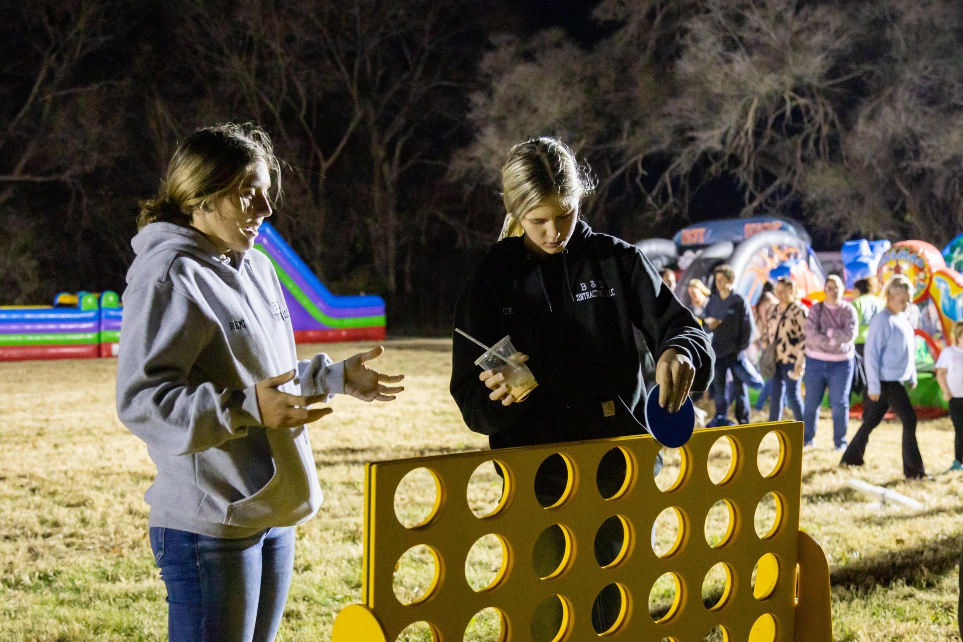 People stand around and laugh at ICL's fall family picnic.