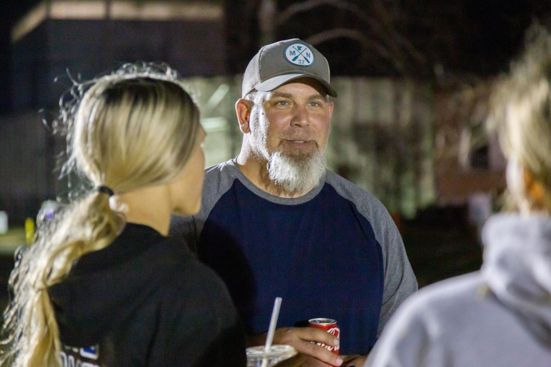 A man and a woman stand and talk at the Fall Family Picnic for ICL.