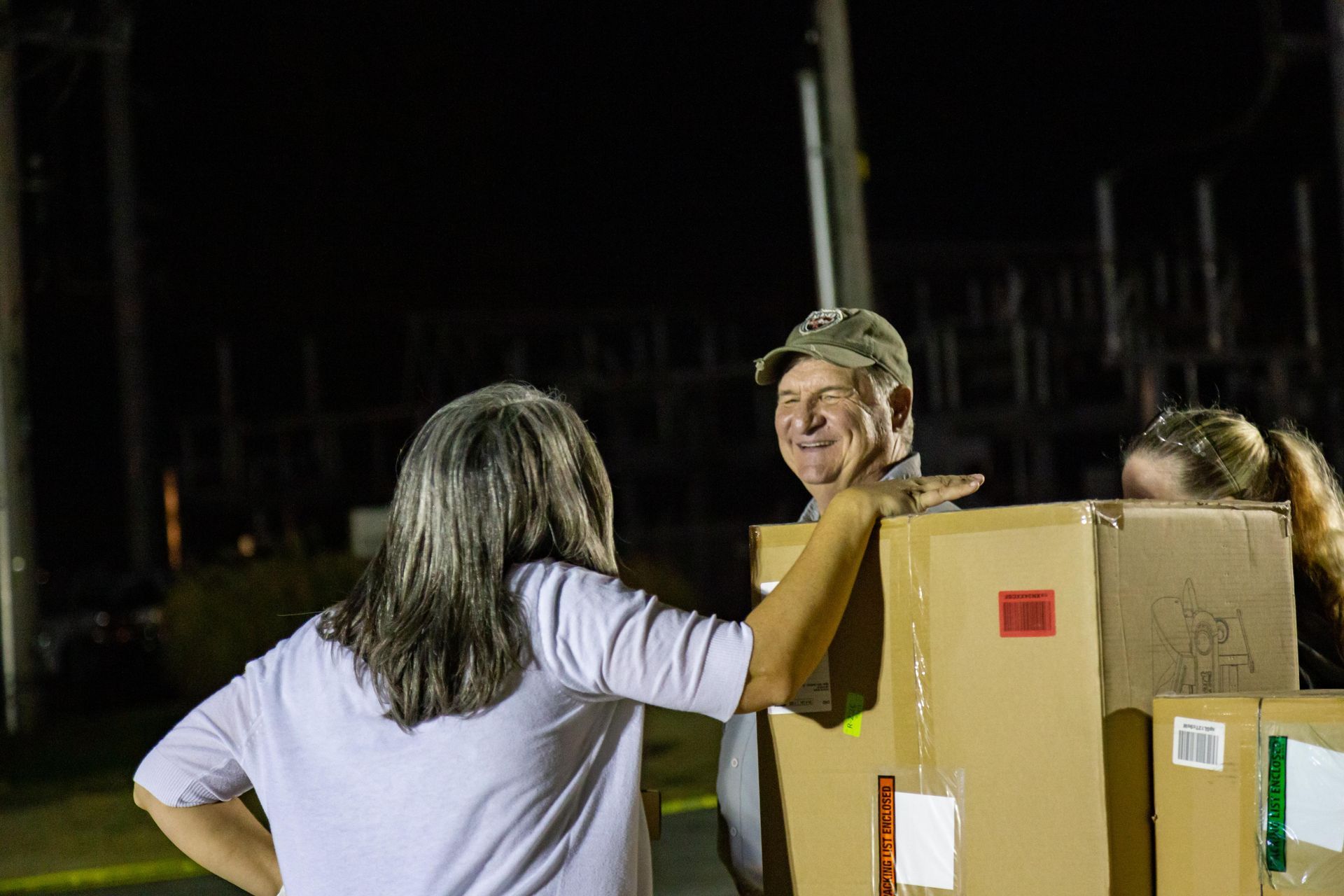 People stand around and laugh at ICL's fall family picnic.