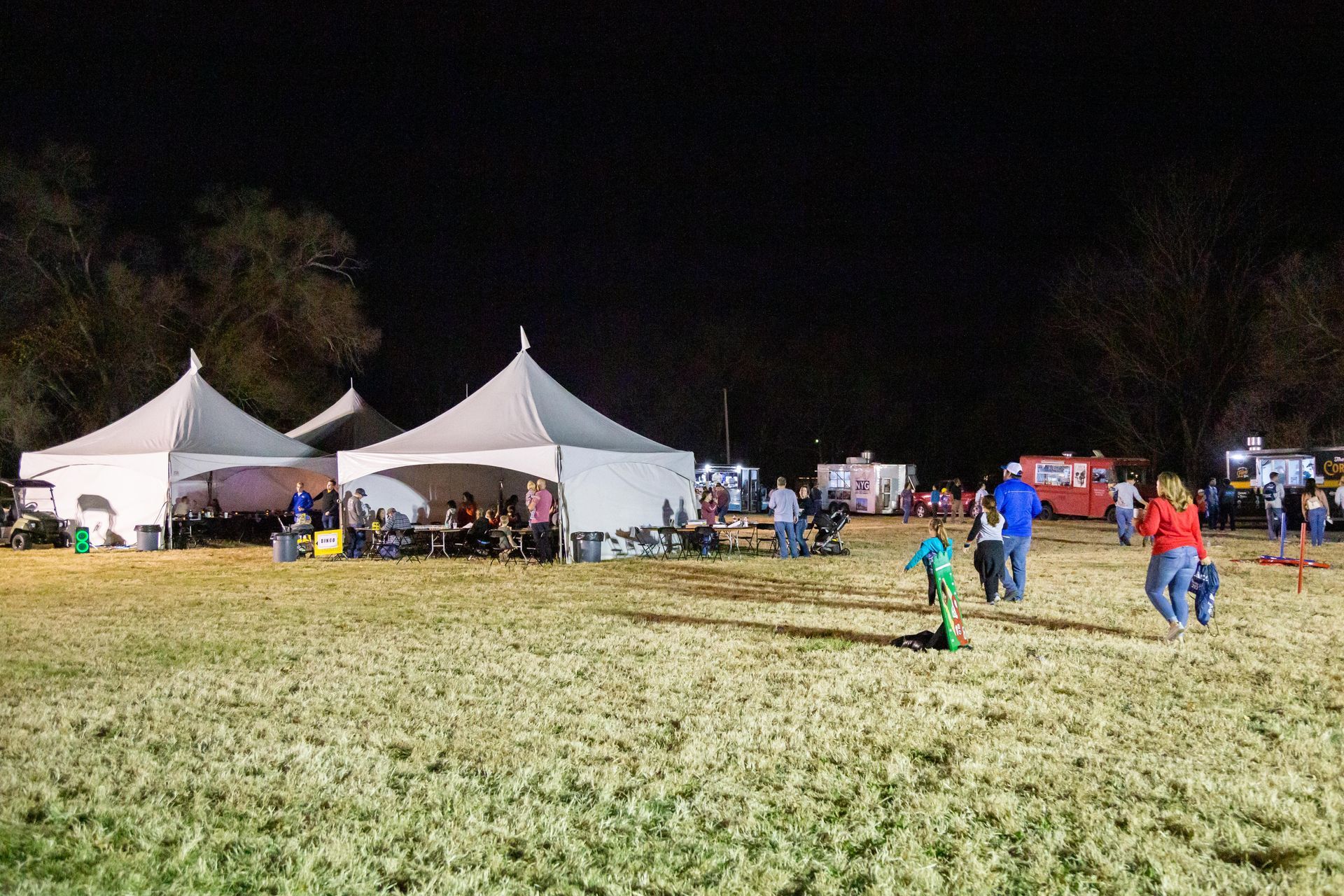 Family fall picnic at night with large tents.