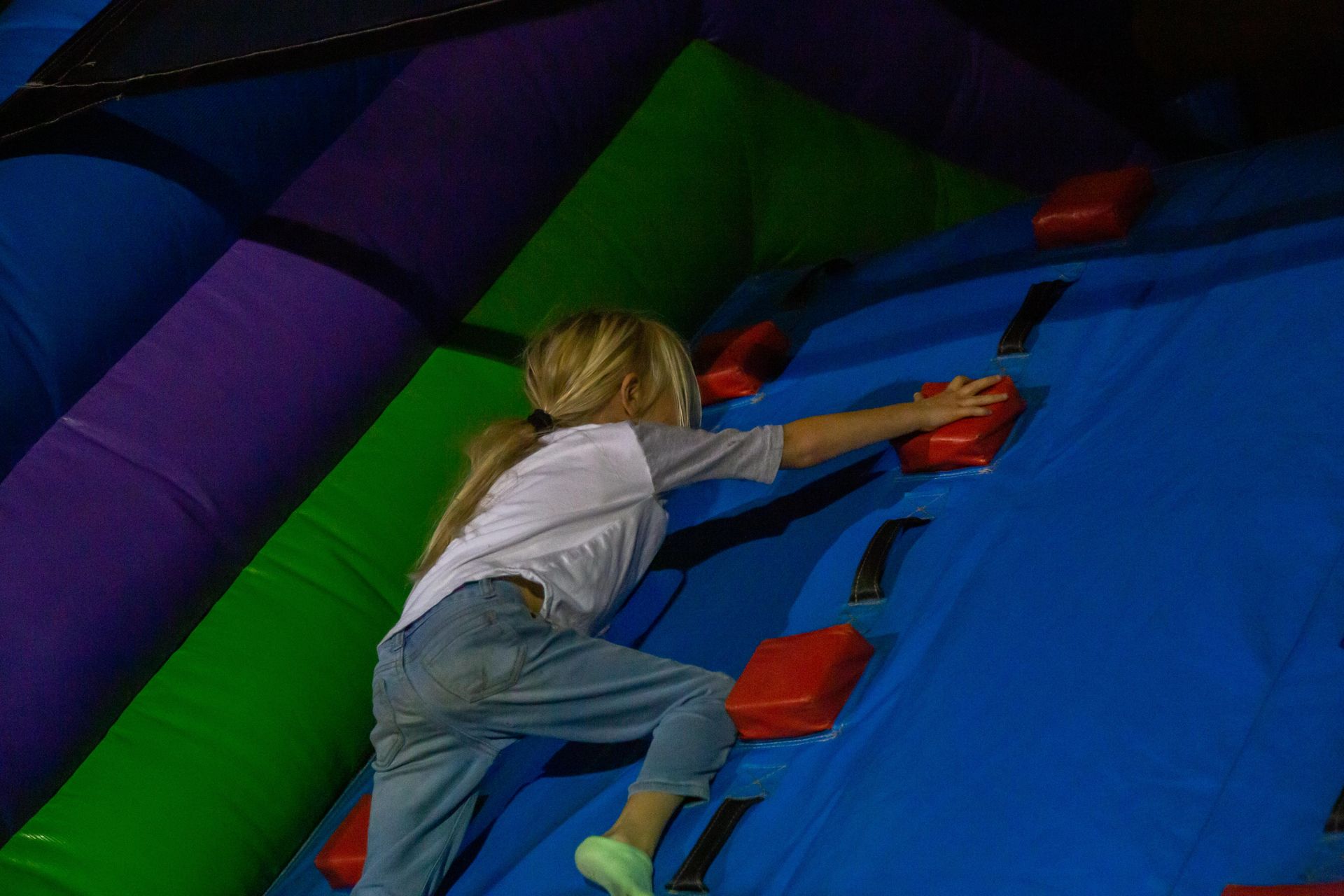 A child climbs a bounce house.