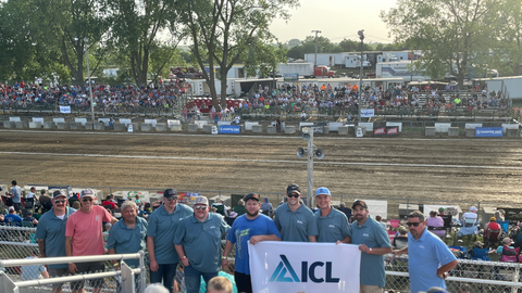 People are standing around at the Tractor Pull.
