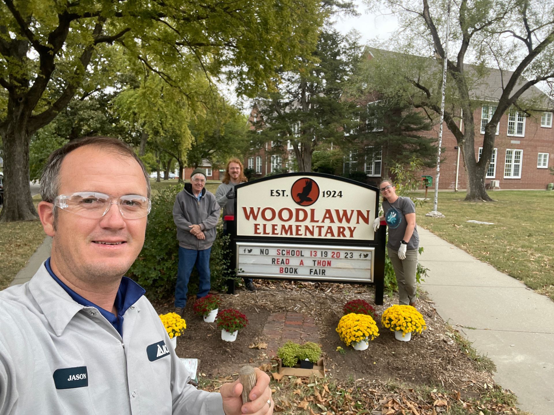 ICL employee is at Woodlawn Elementary school to help plant flowers.