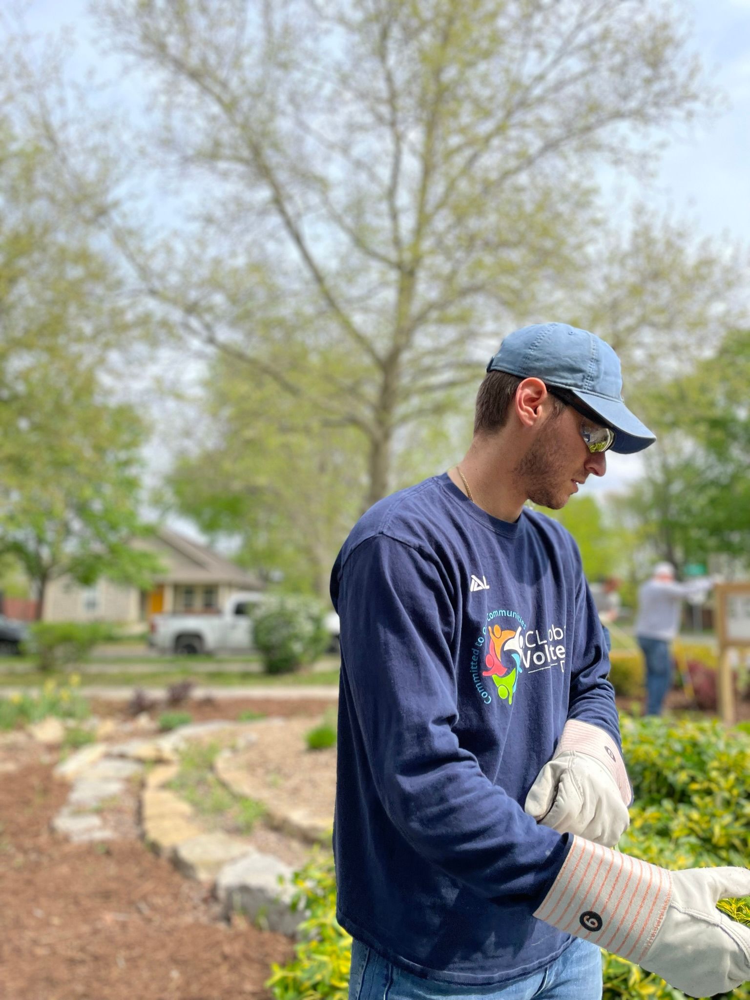 A man looks down at work that needs to be done a the Community Garden.