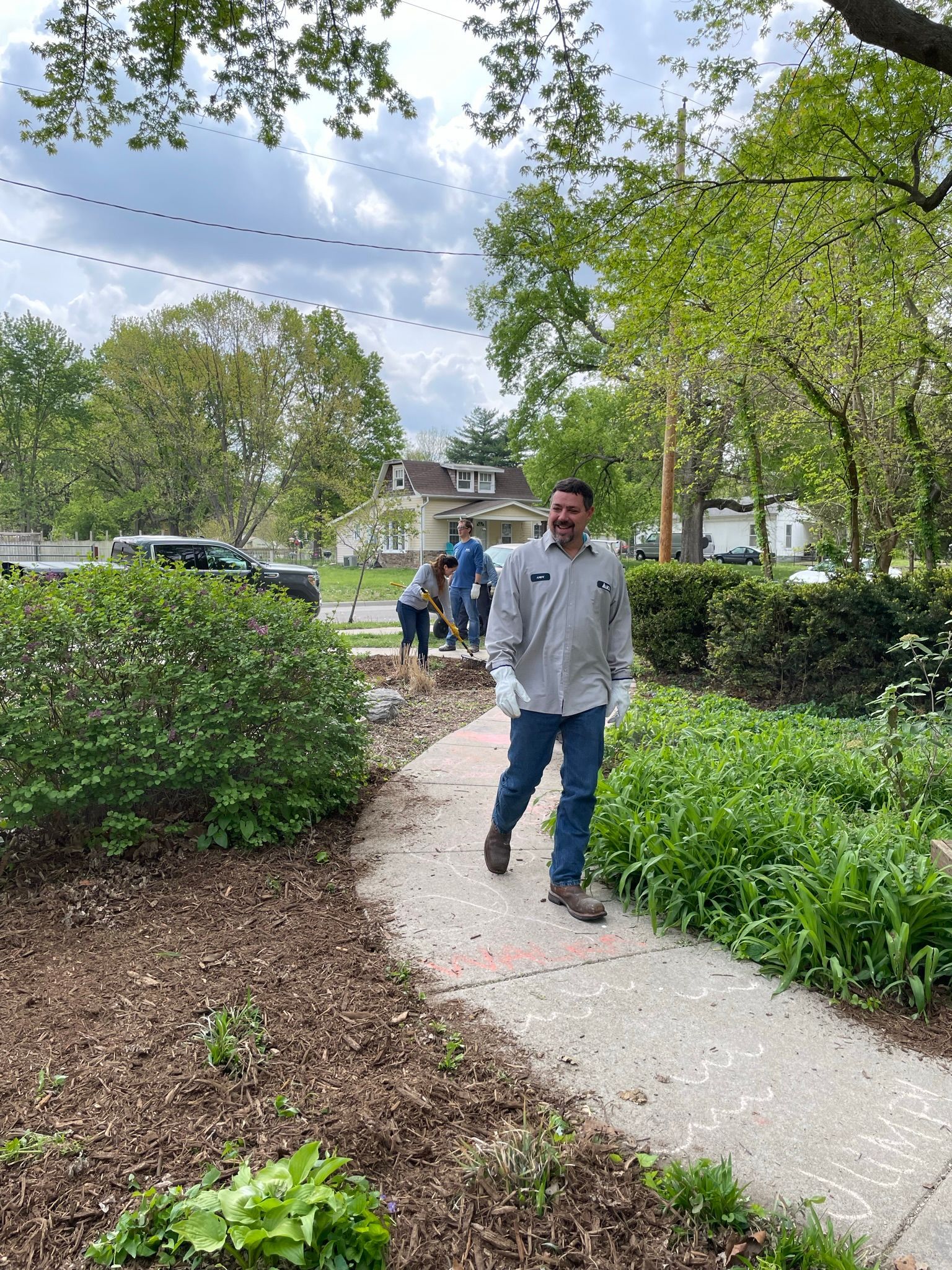 A man walks by the camera and smiles at the Community Garden.