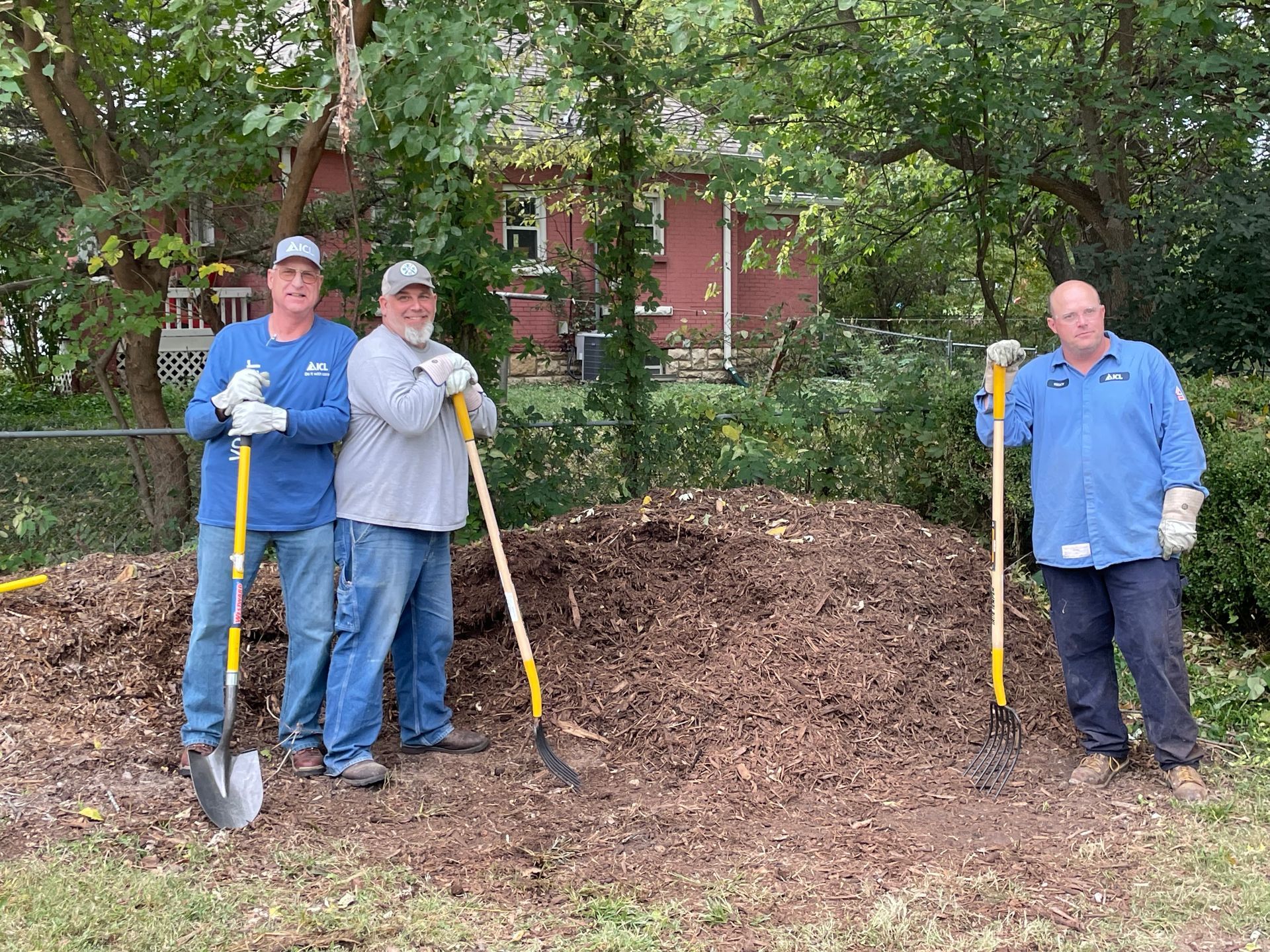 ICL employee is at Woodlawn Elementary school to help plant flowers.