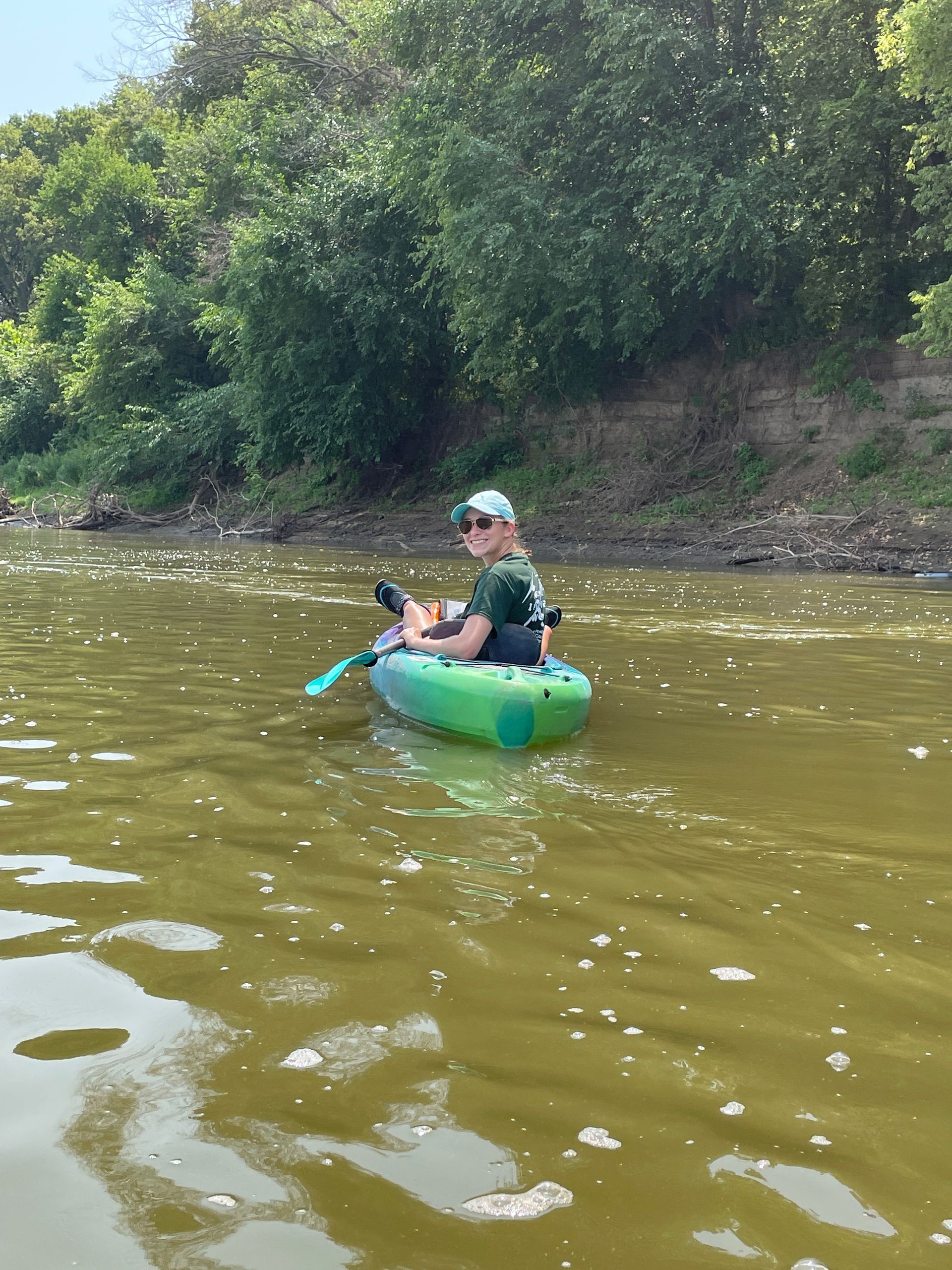 ICL employee in her boat and floating down the river.