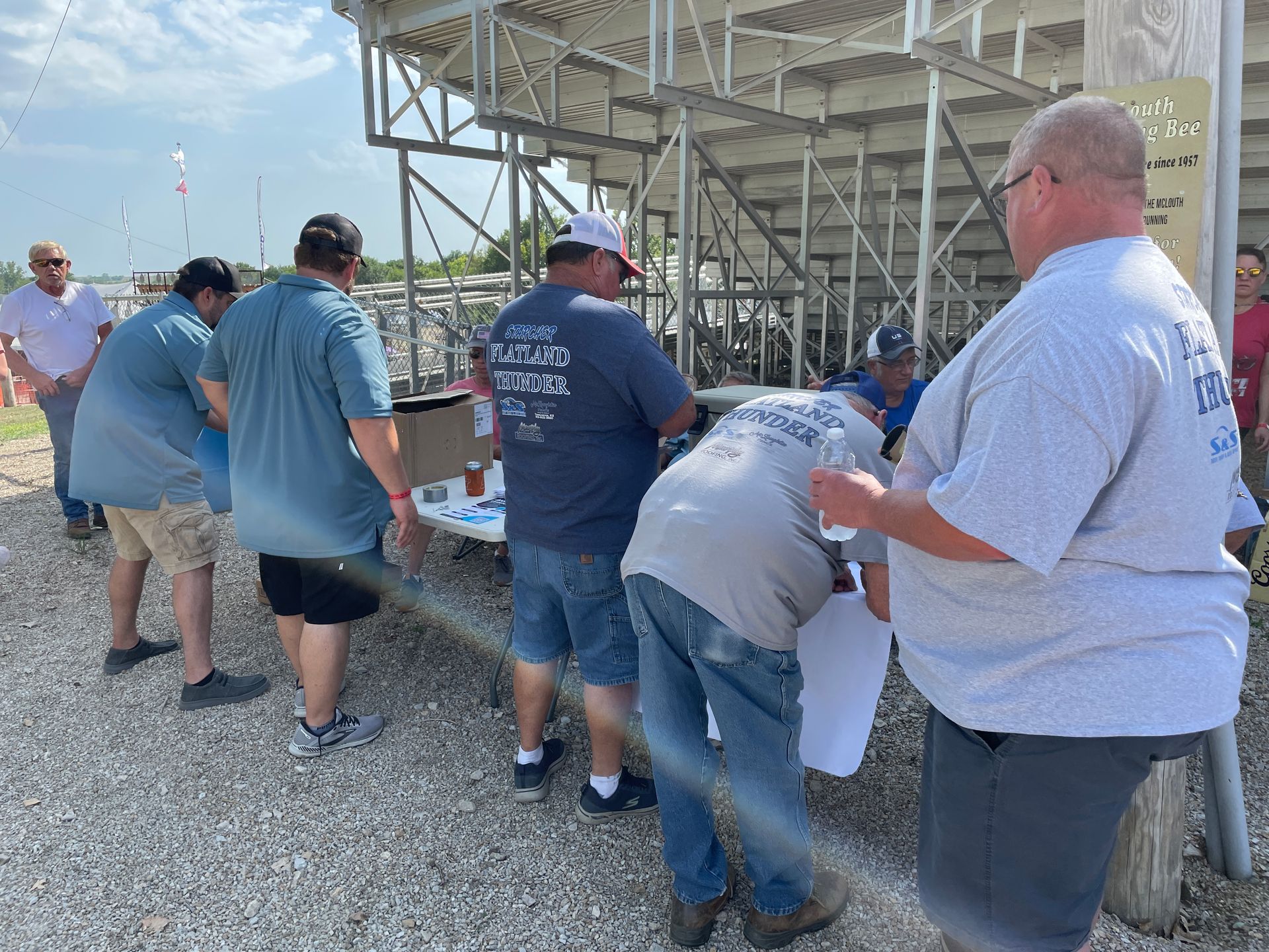 People are standing around at the Tractor Pull.