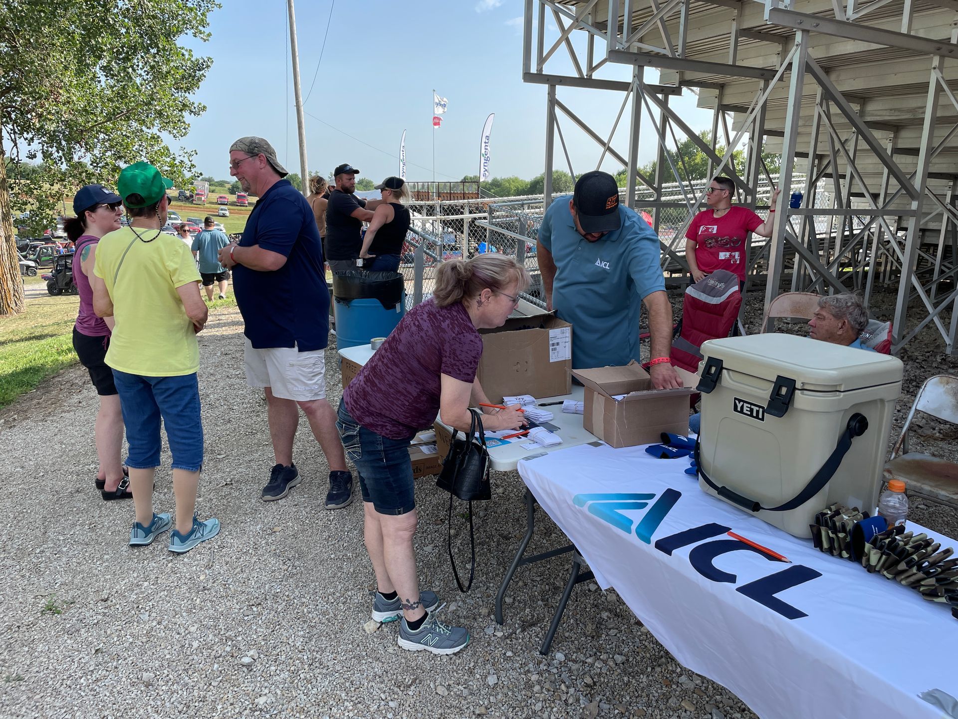 People are standing around at the Tractor Pull.