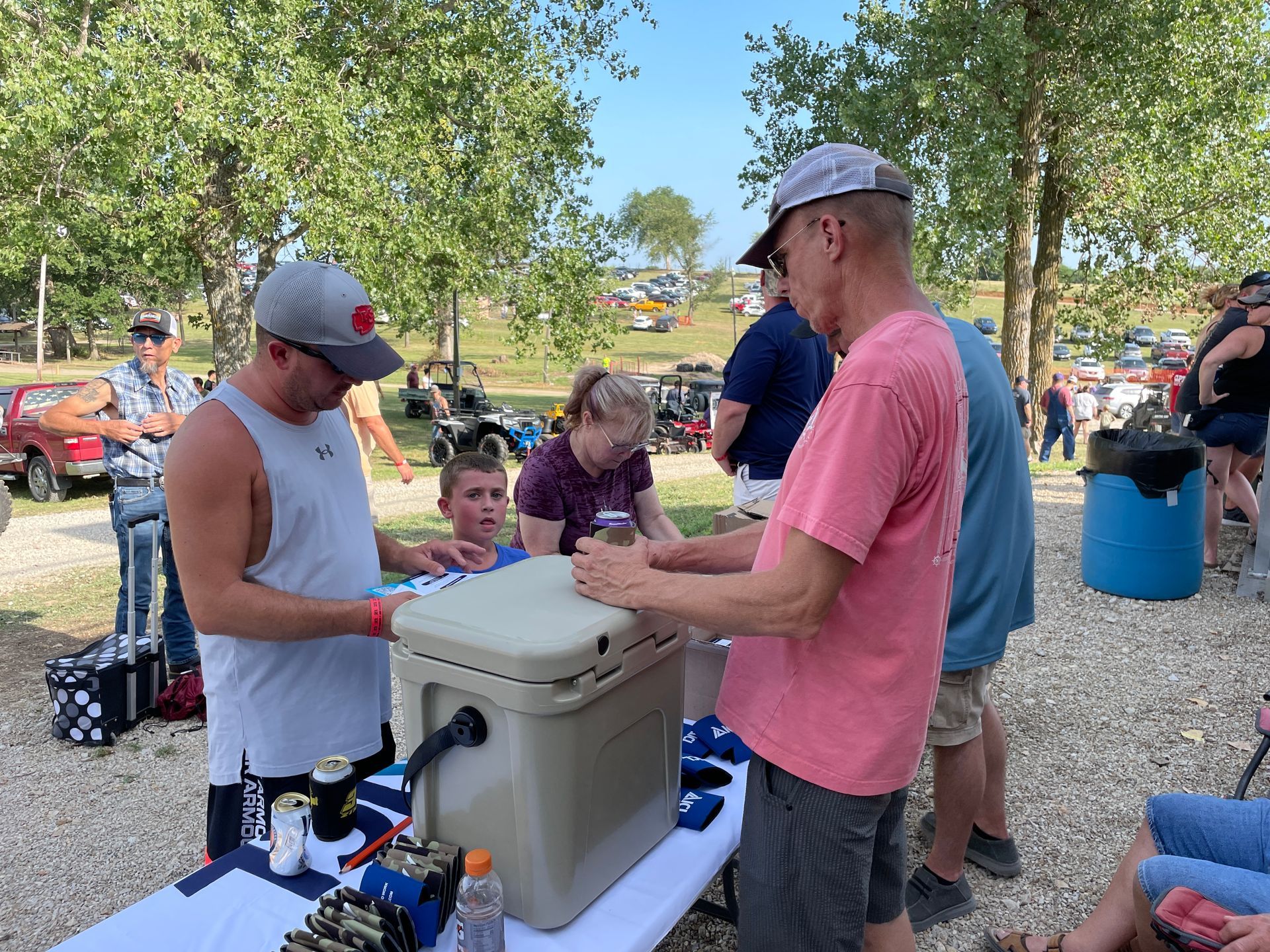 People are standing around at the Tractor Pull.