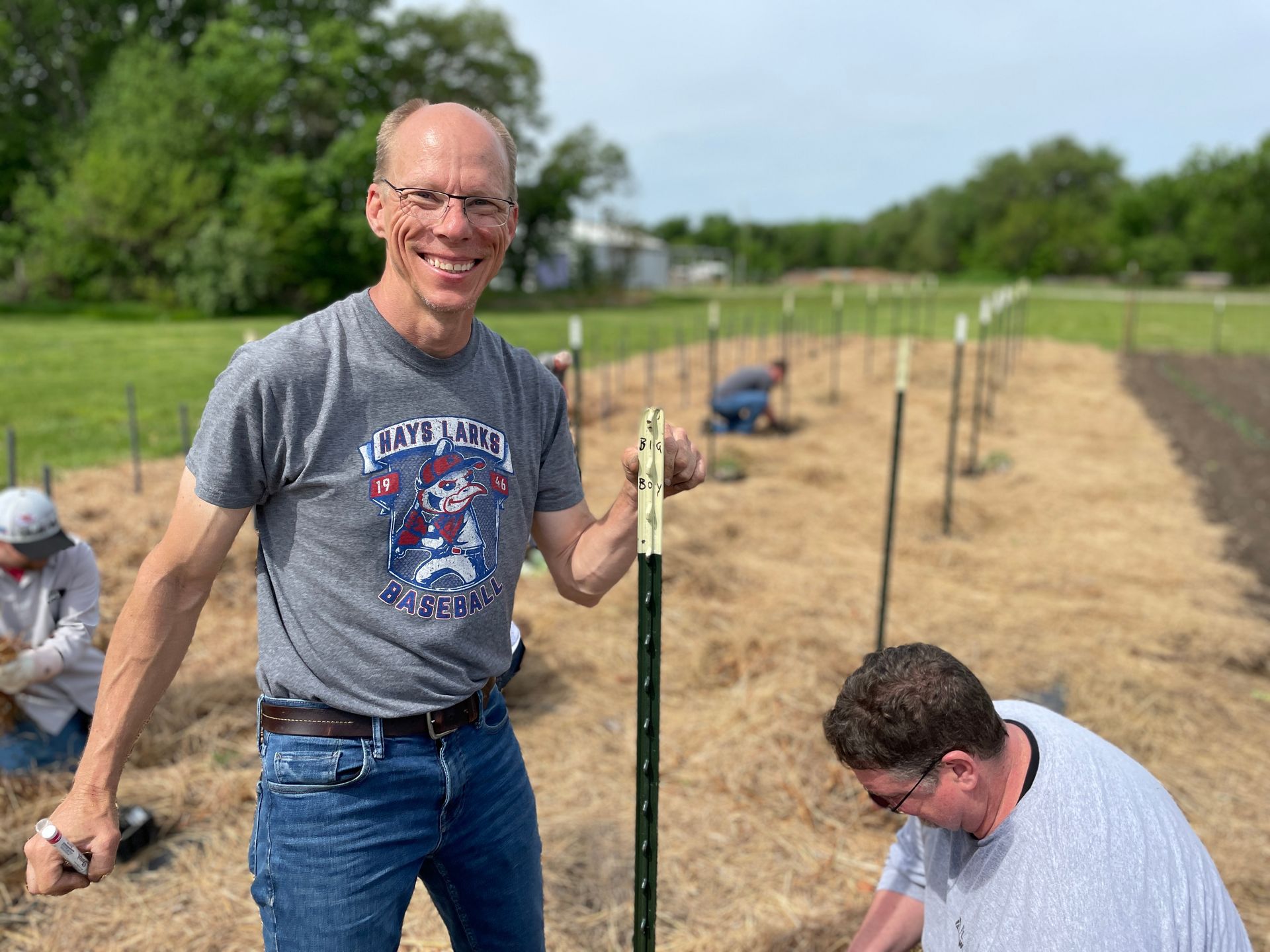 A man smiles at the camera at the Spring planting for ICL.