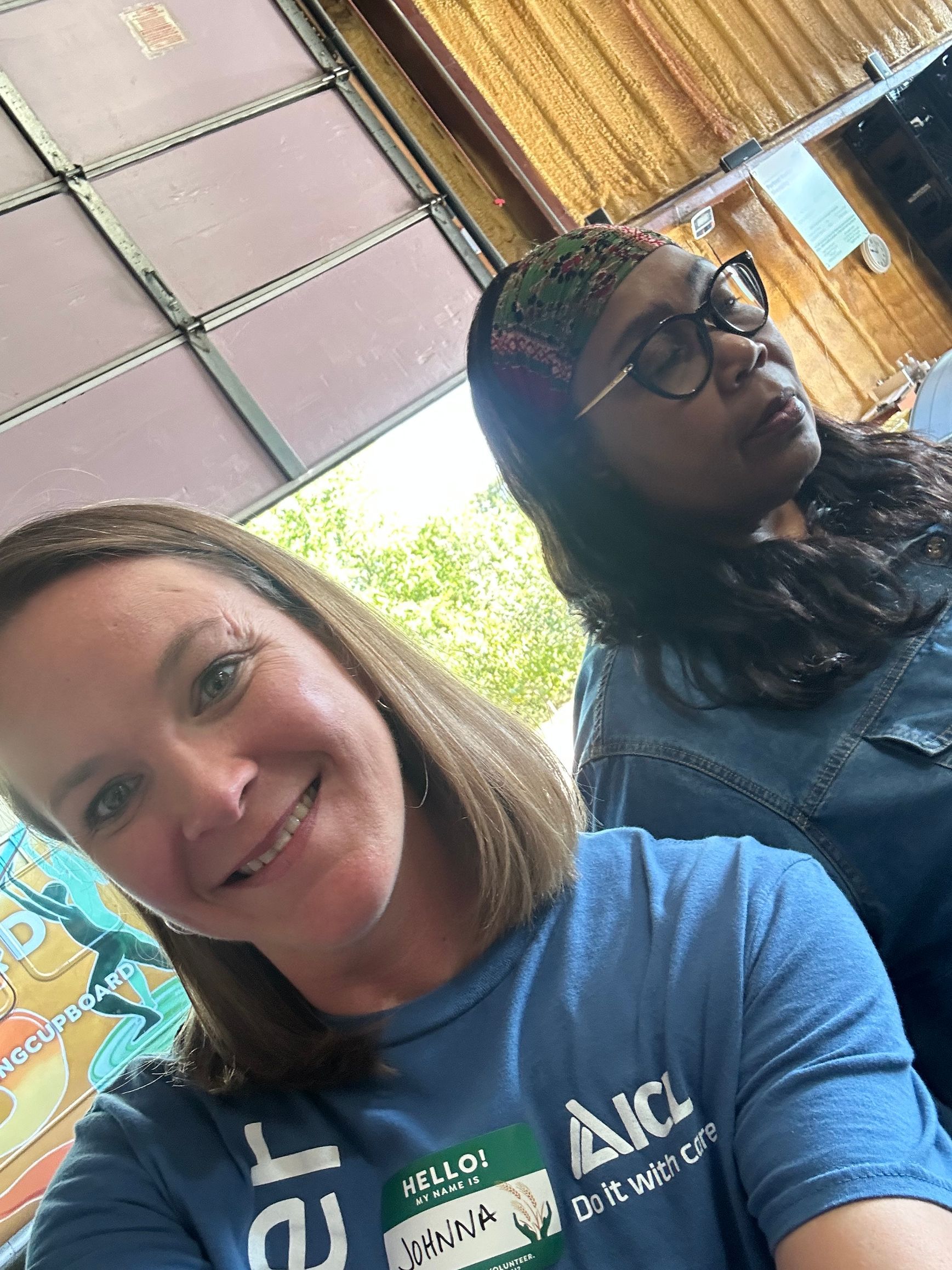 A woman smiles at the camera at the skeet shoot.