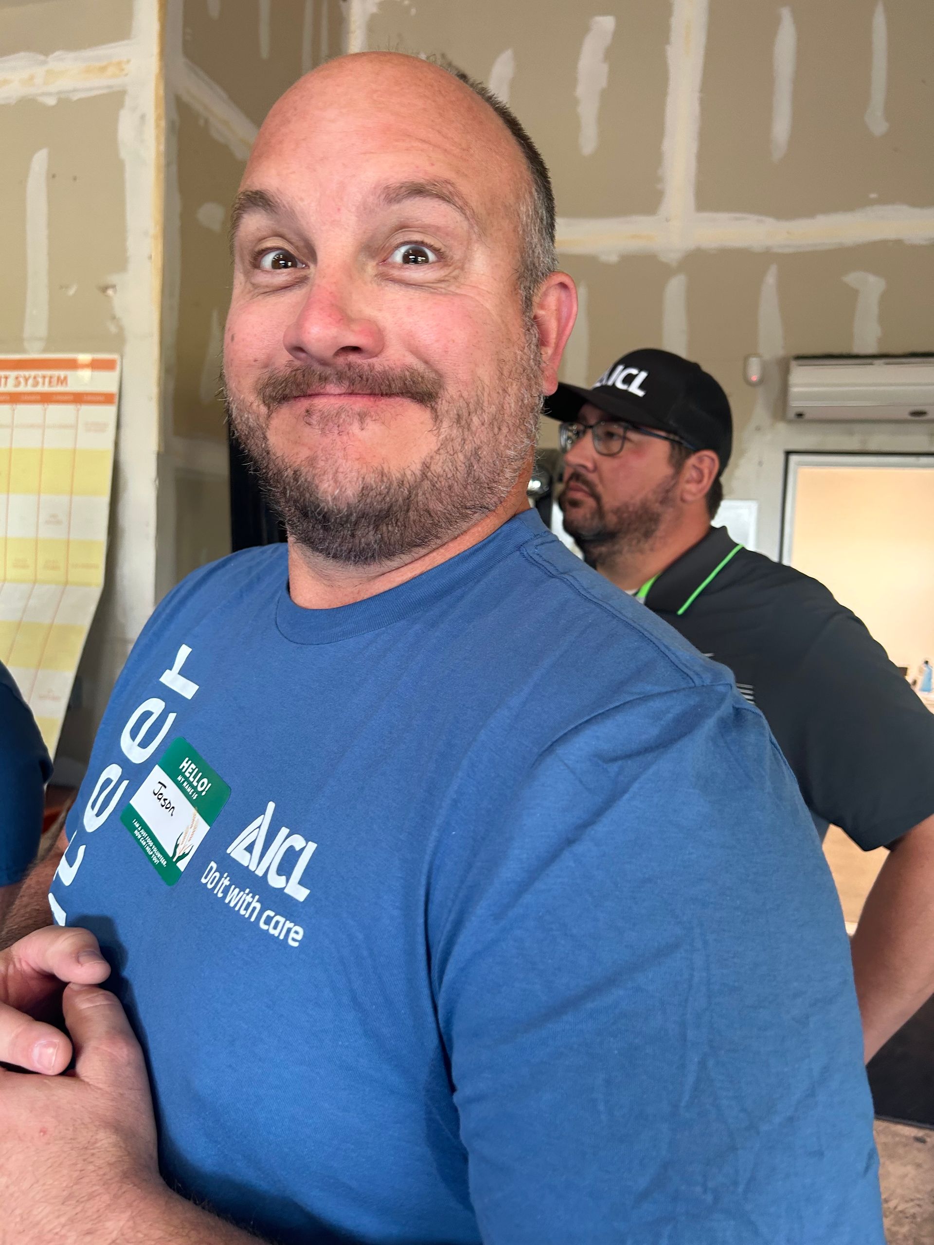 A man smiles for the camera at the skeet shoot party.