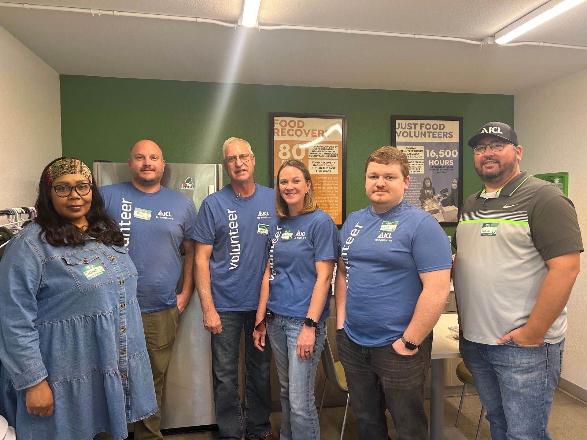 A group of ICL employees smile for the camera at the community food drive.