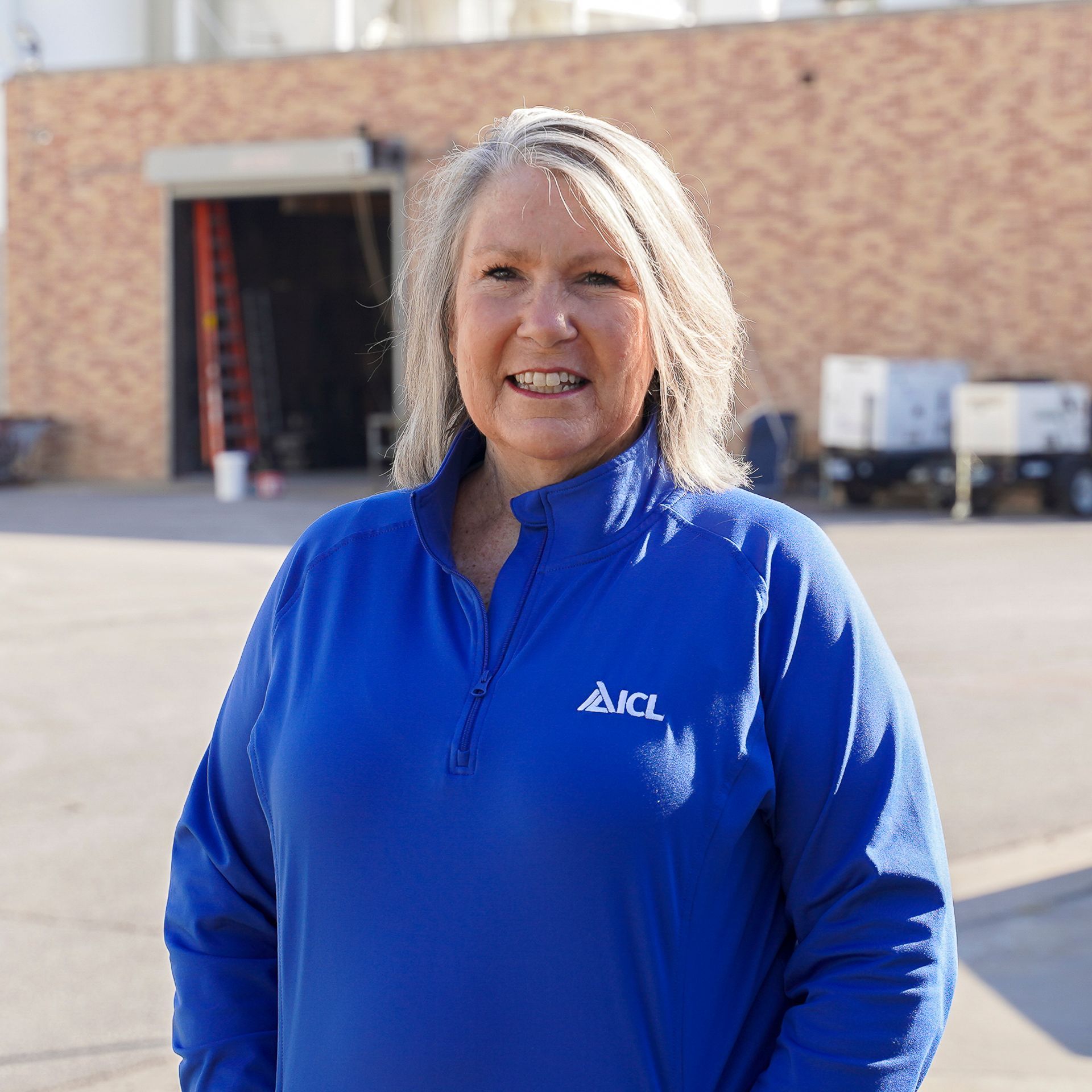 ICL employee smiles for the camera.