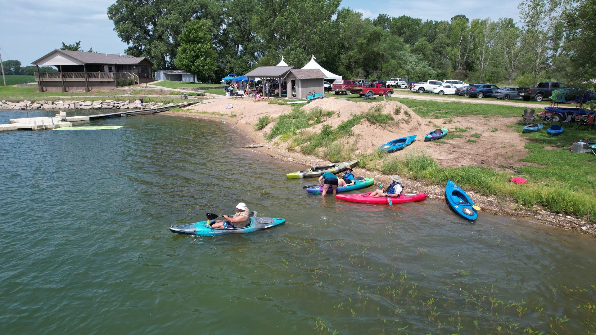 People are getting in their canoes an starting to boat around the lake.