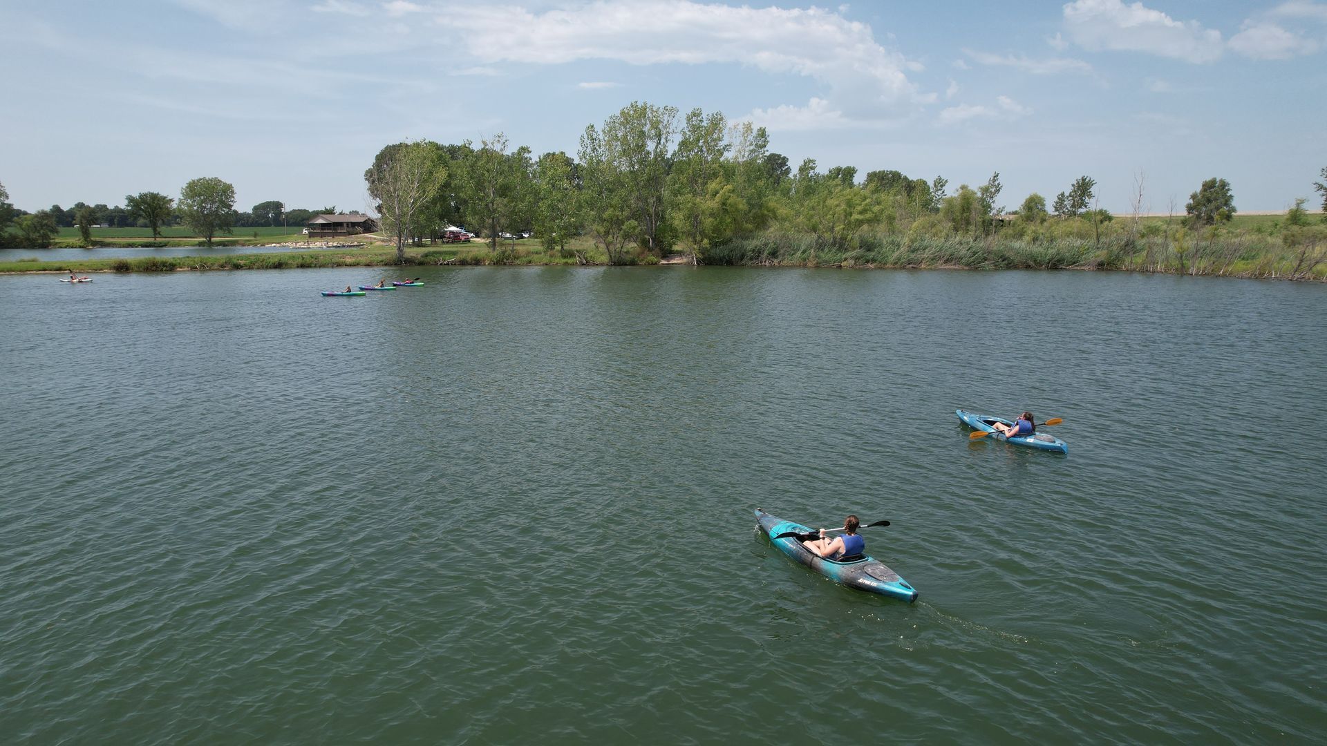 The lake is shown from above with 2 kayaks boating around.