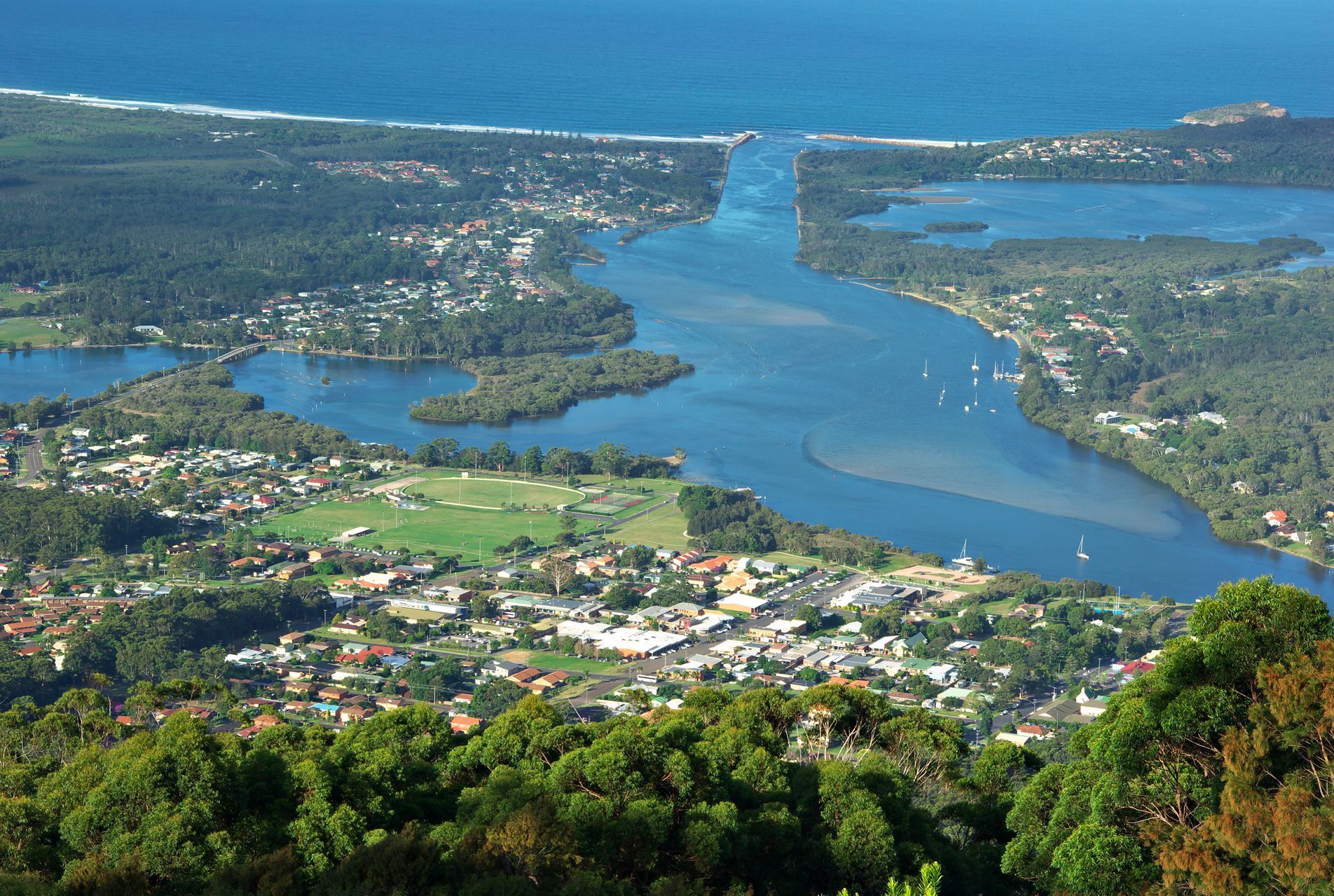 An Aerial View Of A Bridge Over A River At Sunset — Dentures Direct Taree-Rod Hinton In Laurieton, NSW