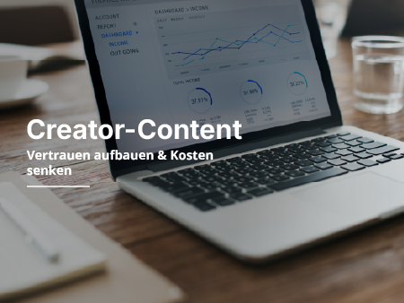 Ein Glas Wasser steht neben einem Laptop auf dem Tisch.