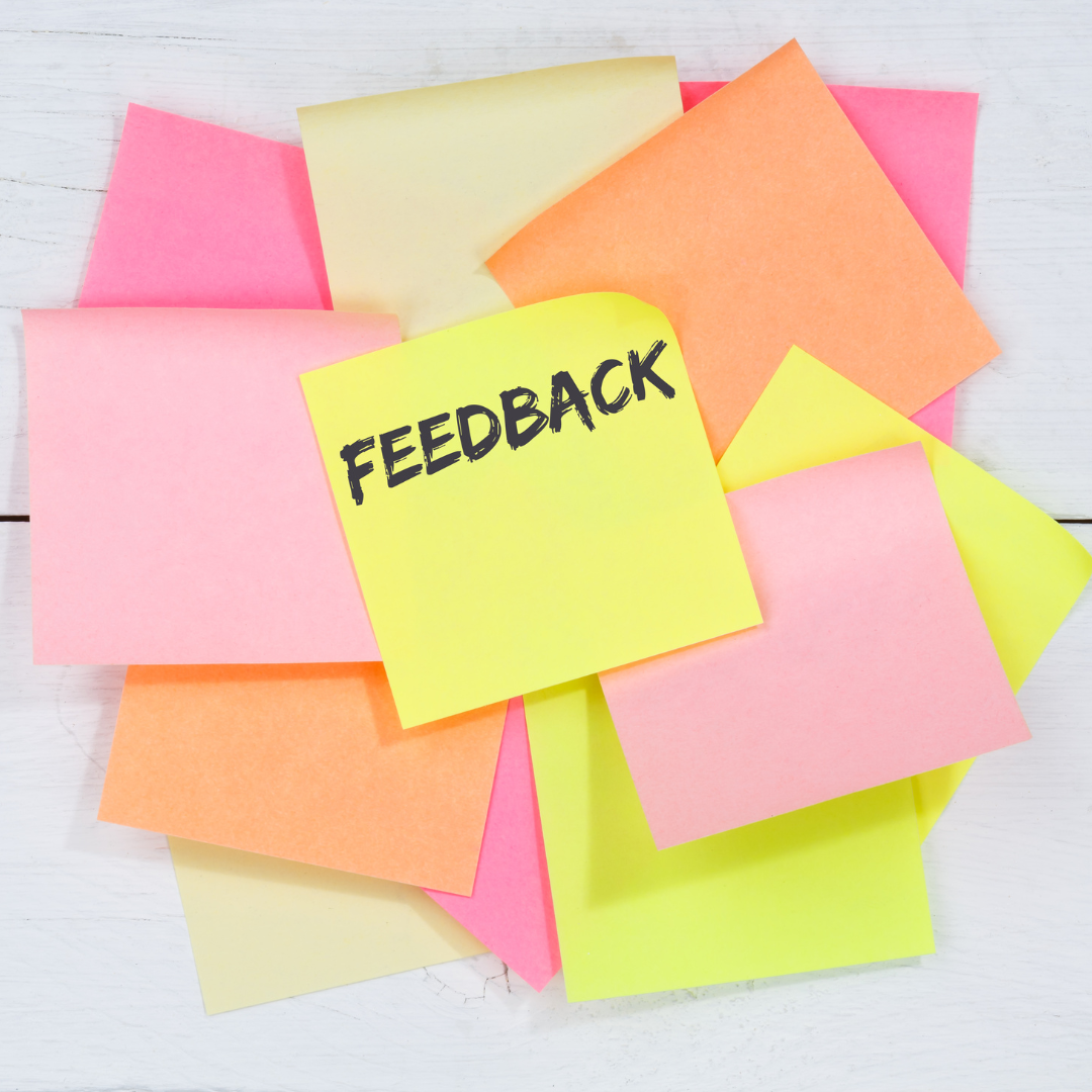 A bunch of sticky notes with one that says feedback