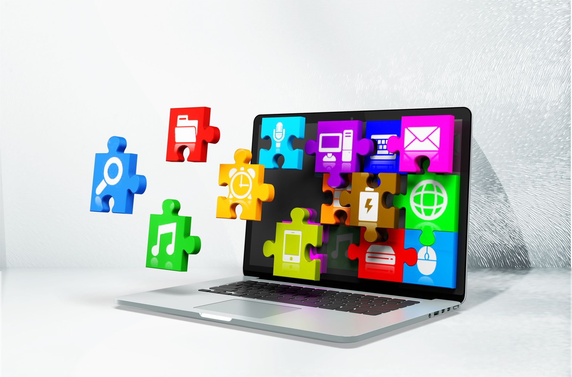 Ein Laptop mit Puzzle-Teilen, die aus dem Bildschirm herausfliegen.