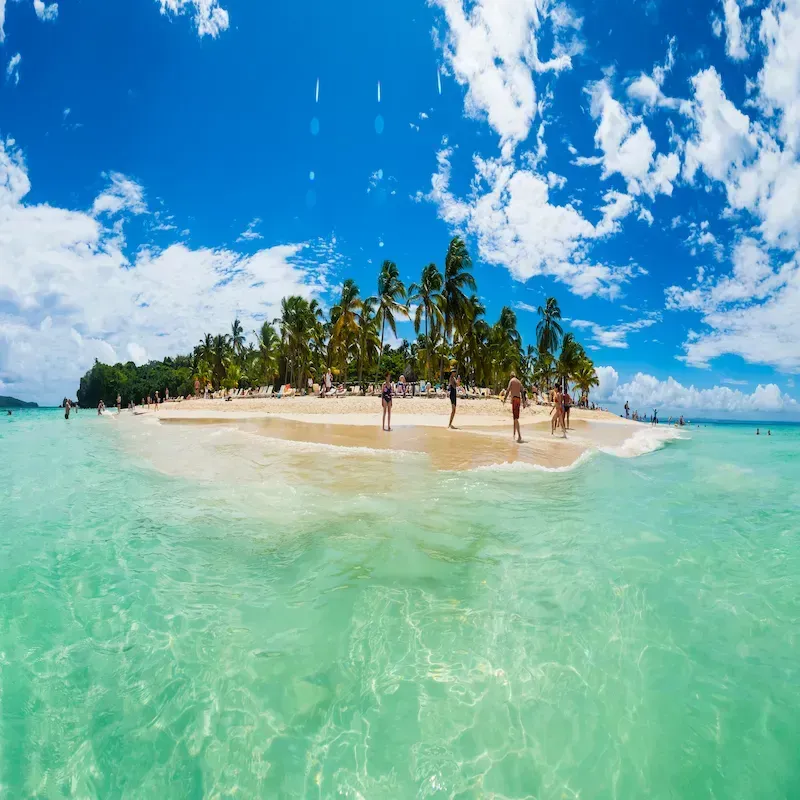 Panoramic view of Cayo Levantado with palm trees, white sand, and turquoise waters off the coast of Miches, Dominican Republic