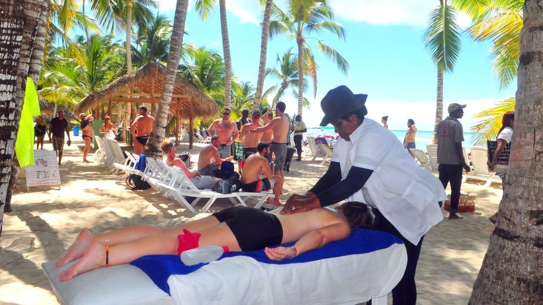 Beach massage experience under palm trees in La Romana Dominican Republic