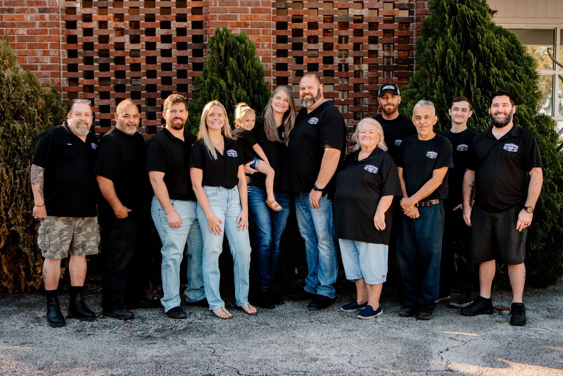 A man is sitting at a counter in a car dealership.