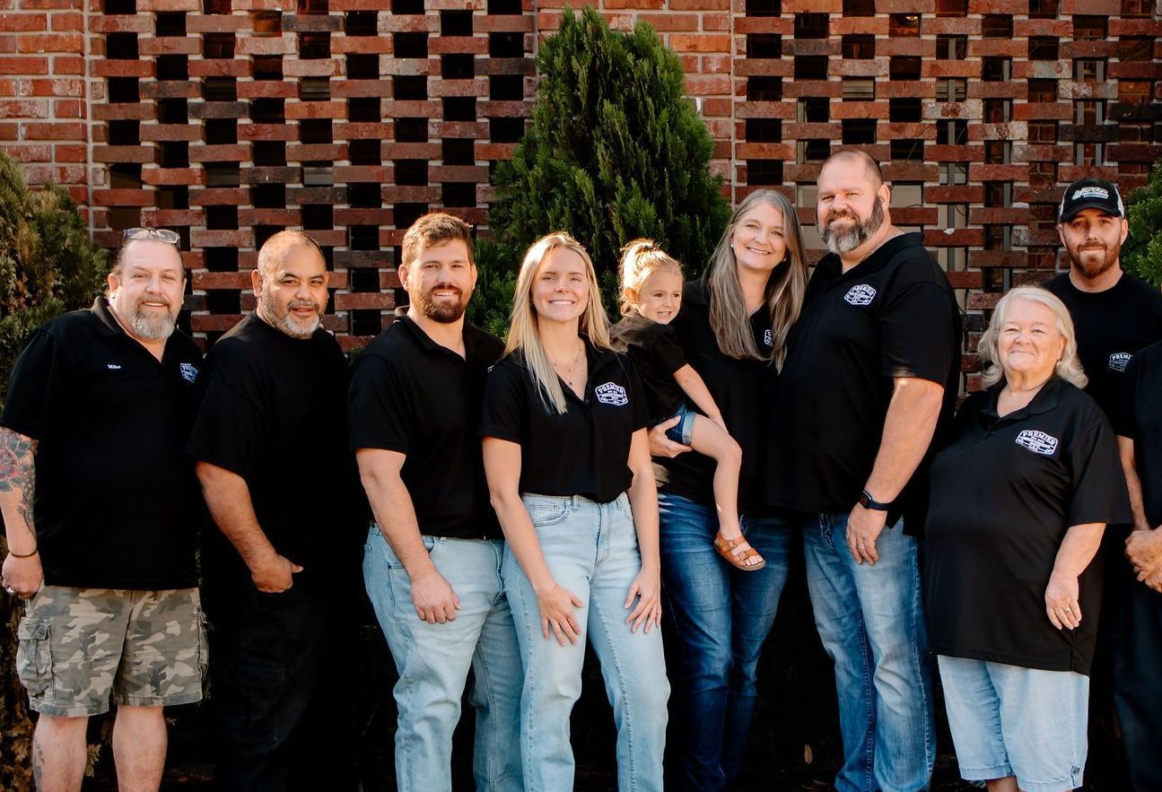 A group of people are posing for a picture in front of a building.