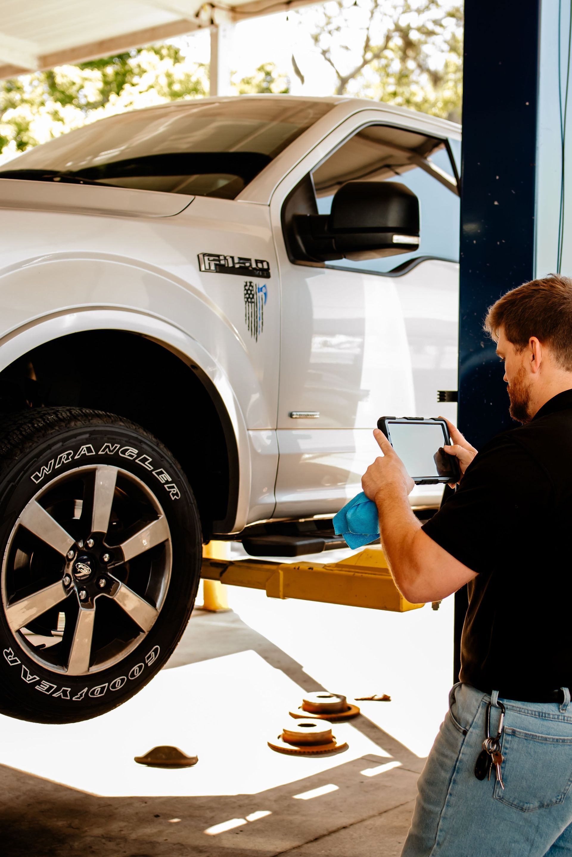 A national shop of the year plaque is sitting on a table in front of a blue toolbox.
