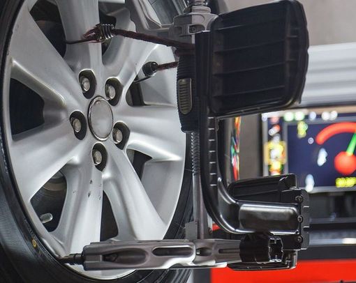 A car wheel is being adjusted by a machine