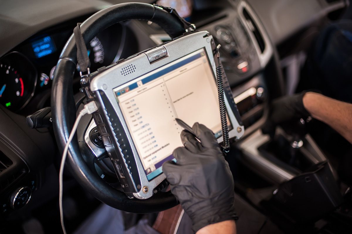 A person is using a tablet in a car.