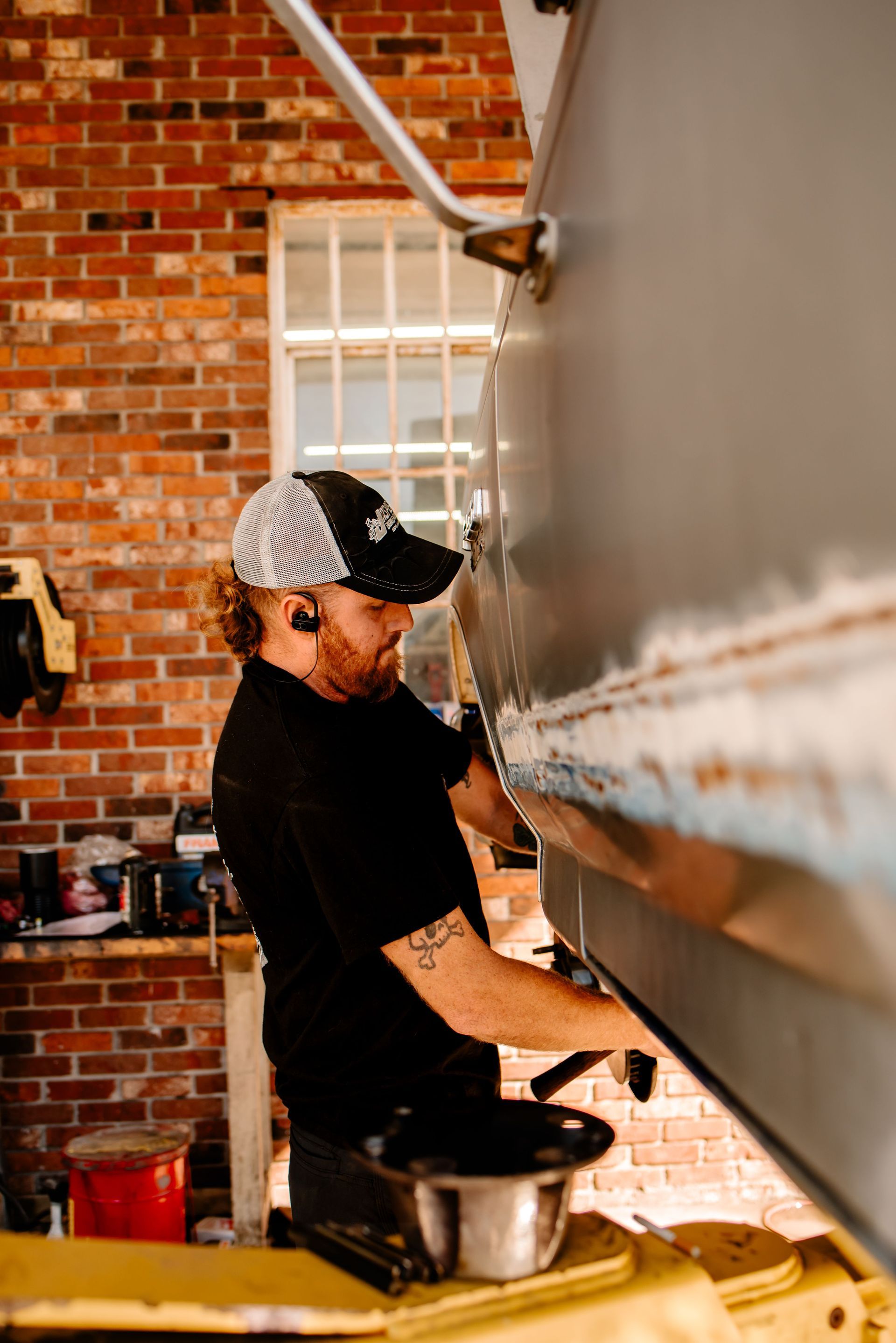 A black and white photo of a car repair shop
