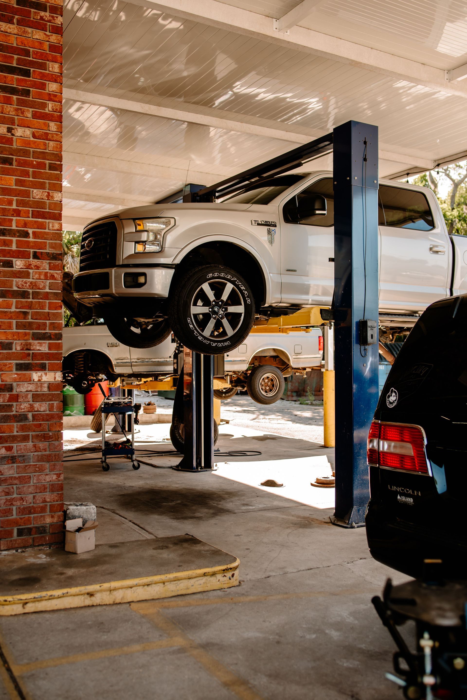 A blue car is parked in front of a car wash.