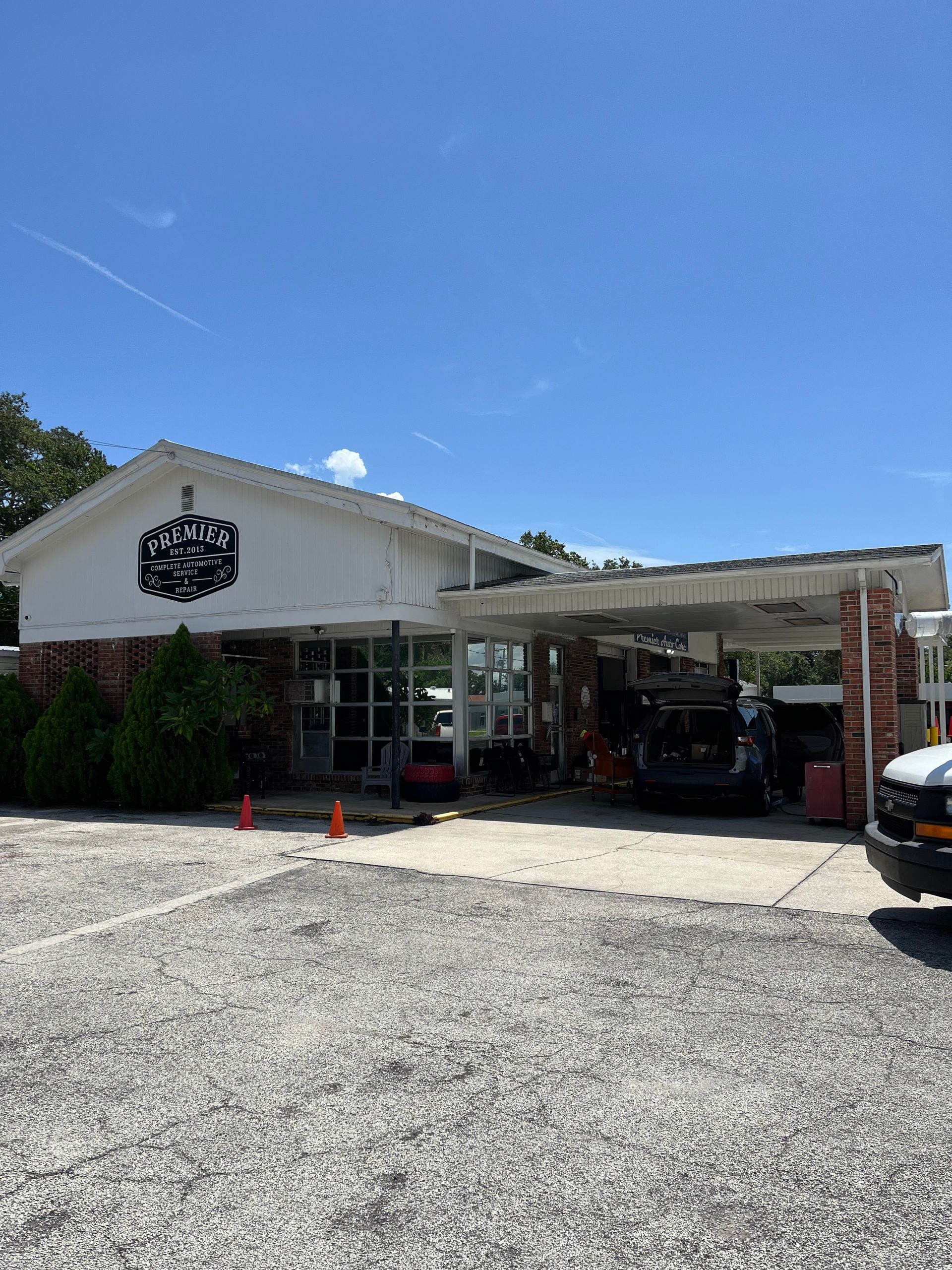 A white van is parked in front of a building.