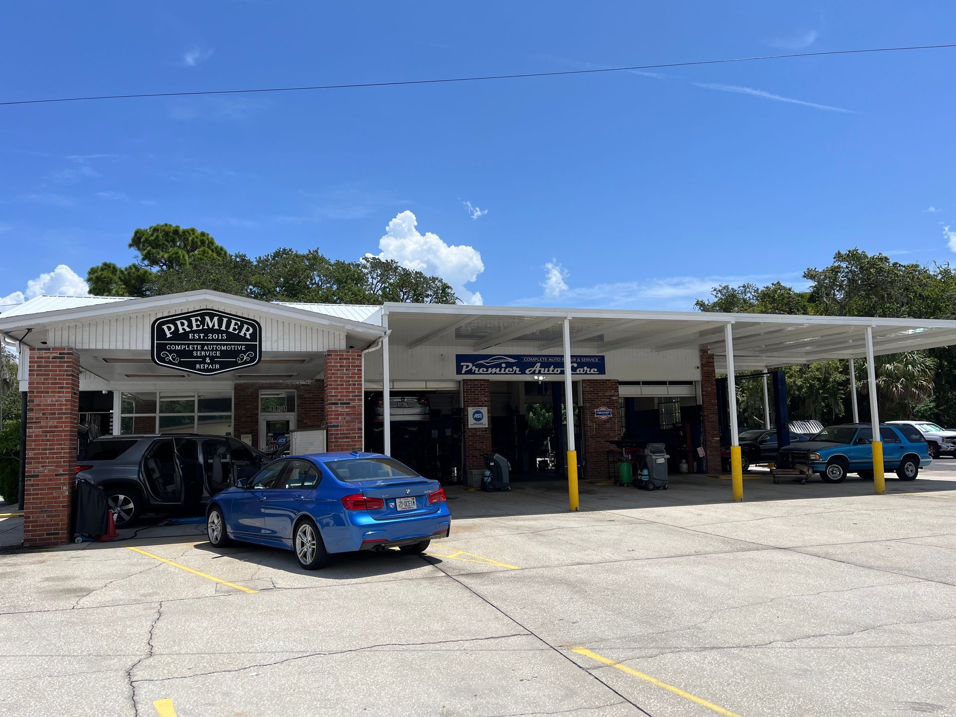 A blue car is parked in front of a car wash.