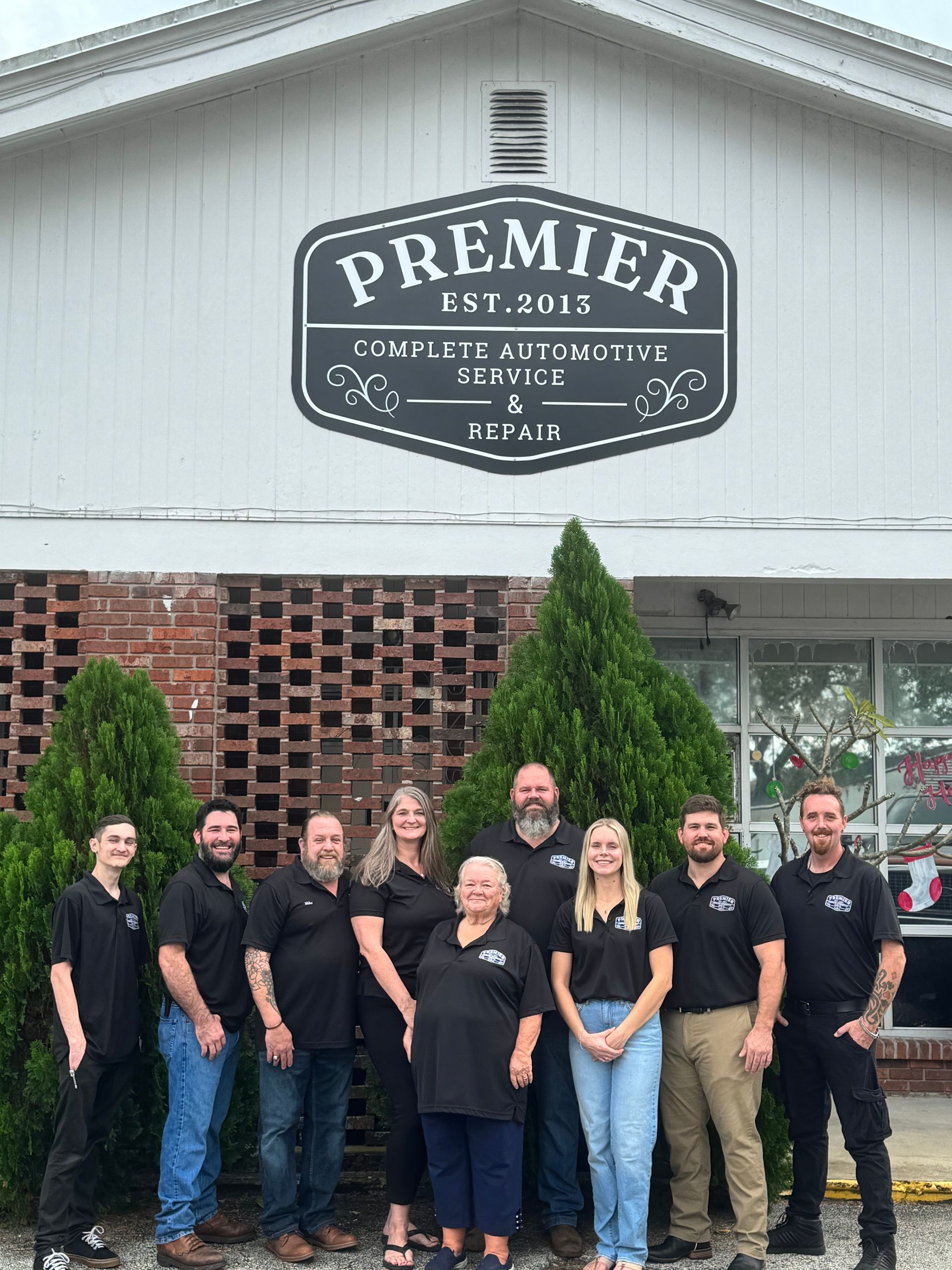 A group of people are posing for a picture in front of a building.