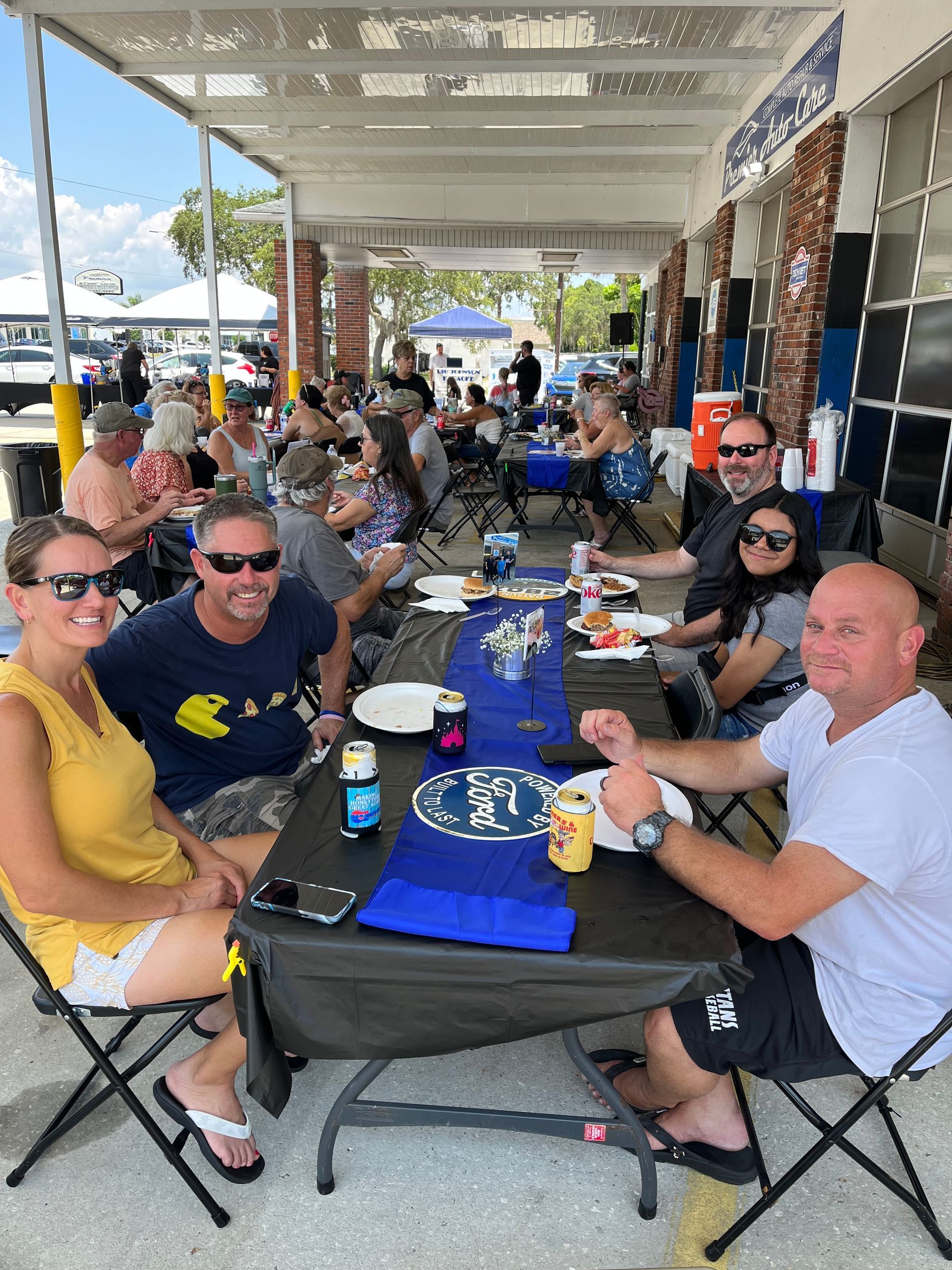 A group of people are sitting around a table eating food.