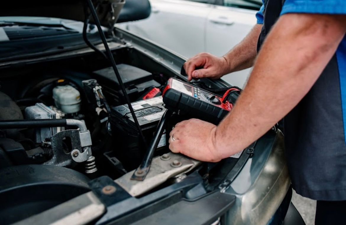 Mans hands working on a vehicles air conditioning under the hood of a customer's car in Titusville Florida 32780, 32796. Car Ac Repair near me