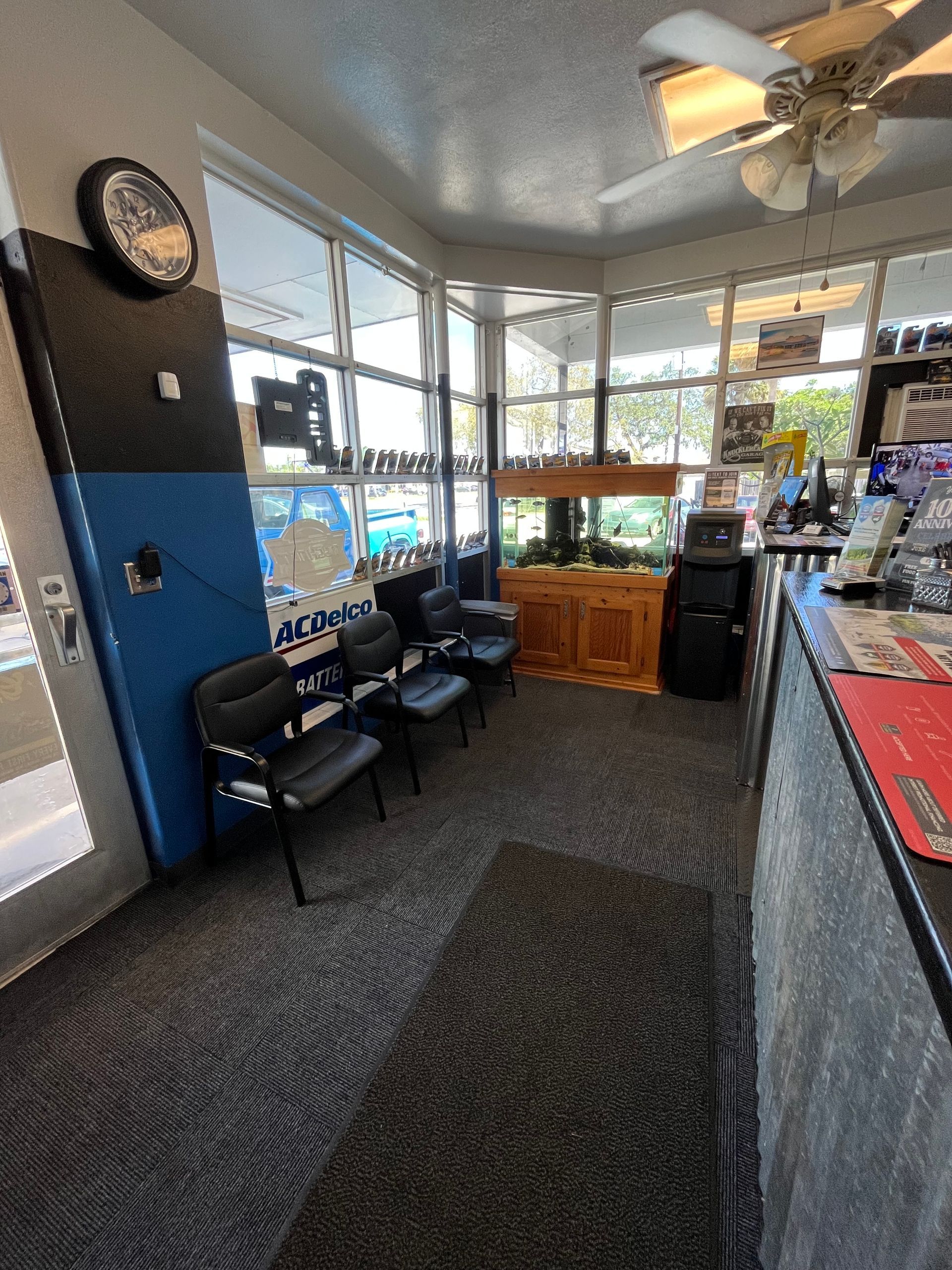 A waiting room with a ceiling fan and a clock on the wall.