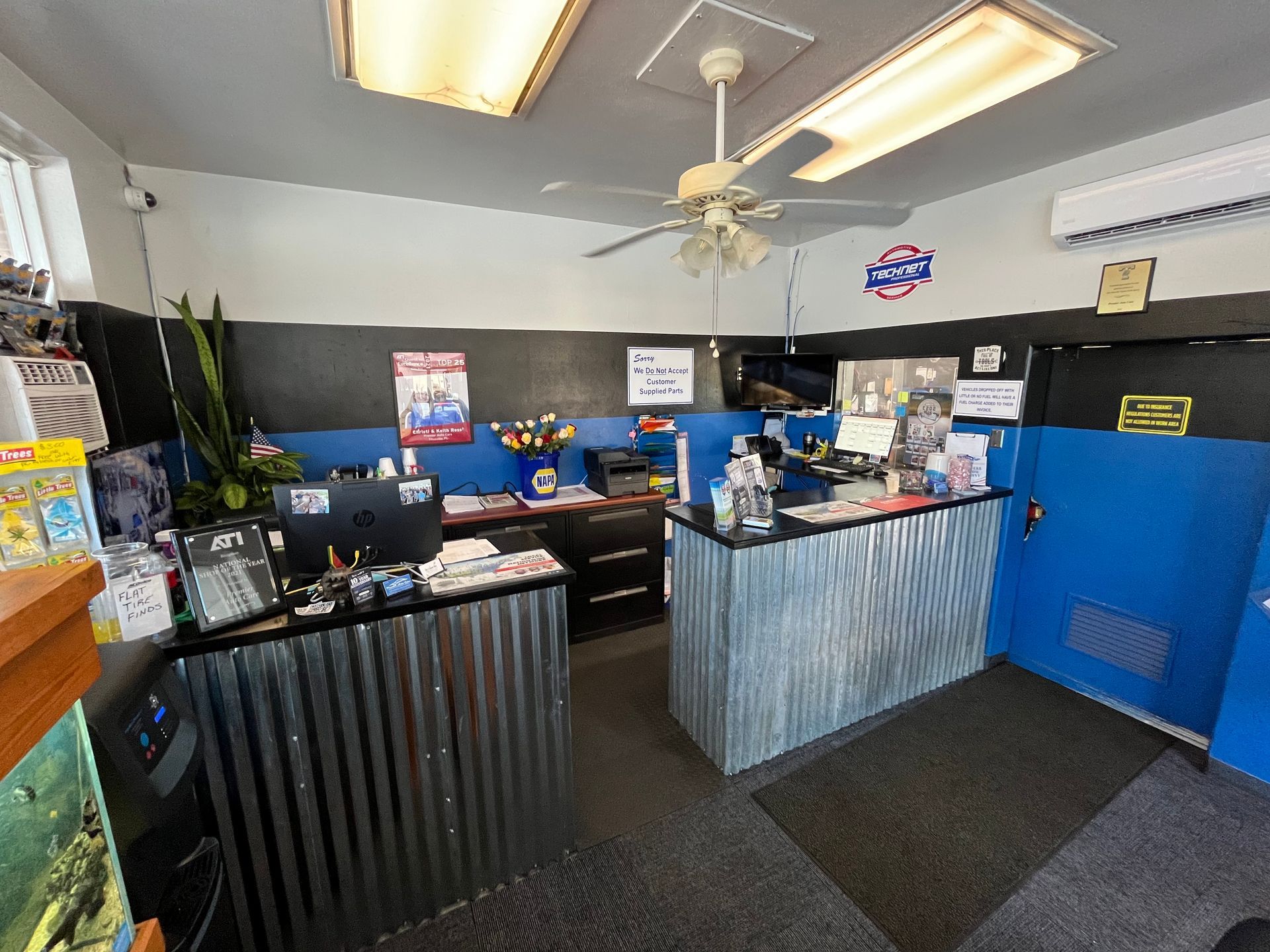 A room with a counter and a ceiling fan in it