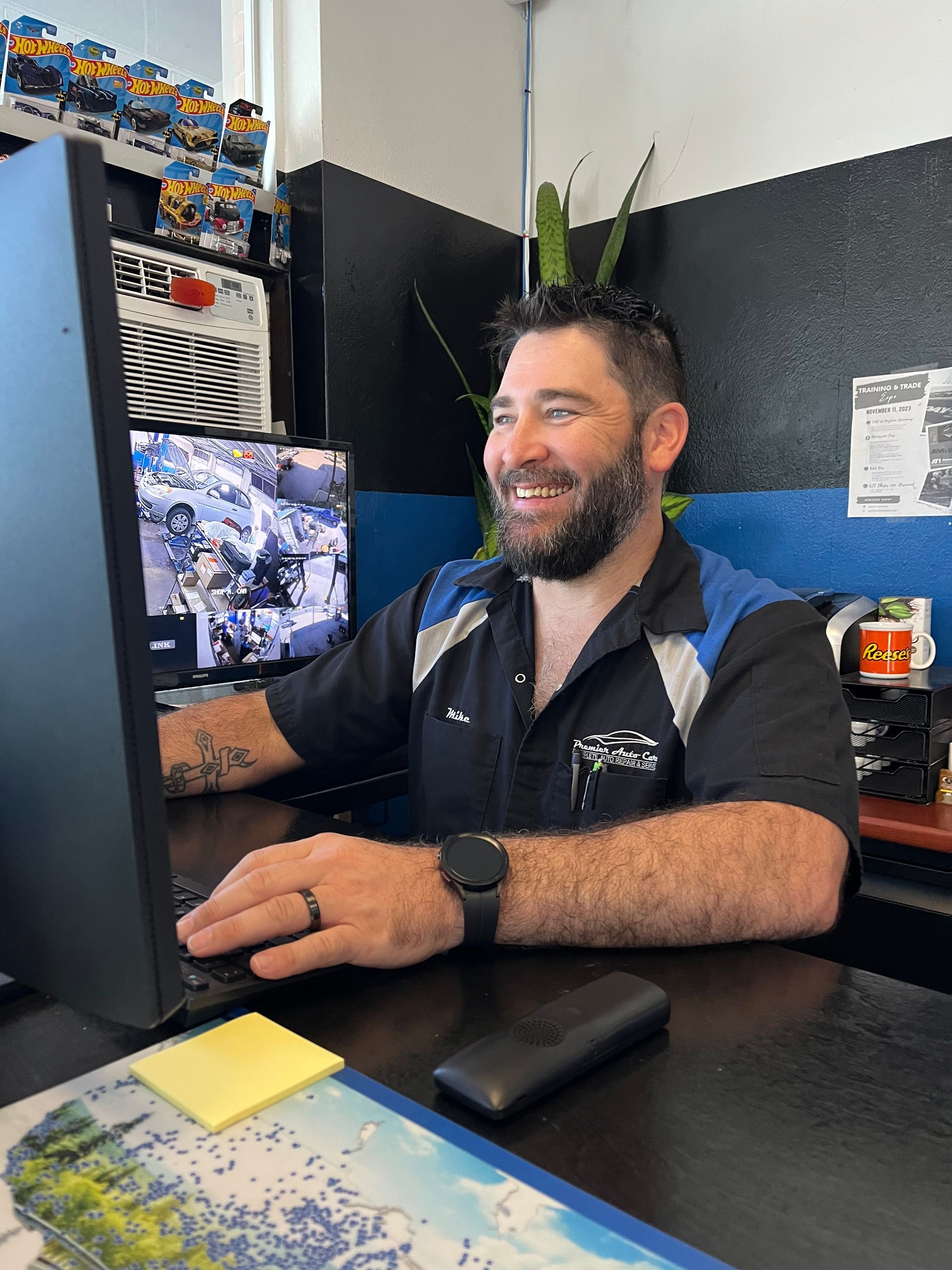 A man is sitting at a desk in front of a computer.