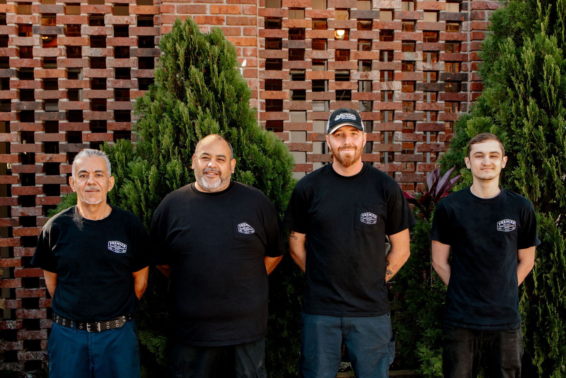 A car is parked in a garage at an auto care shop.