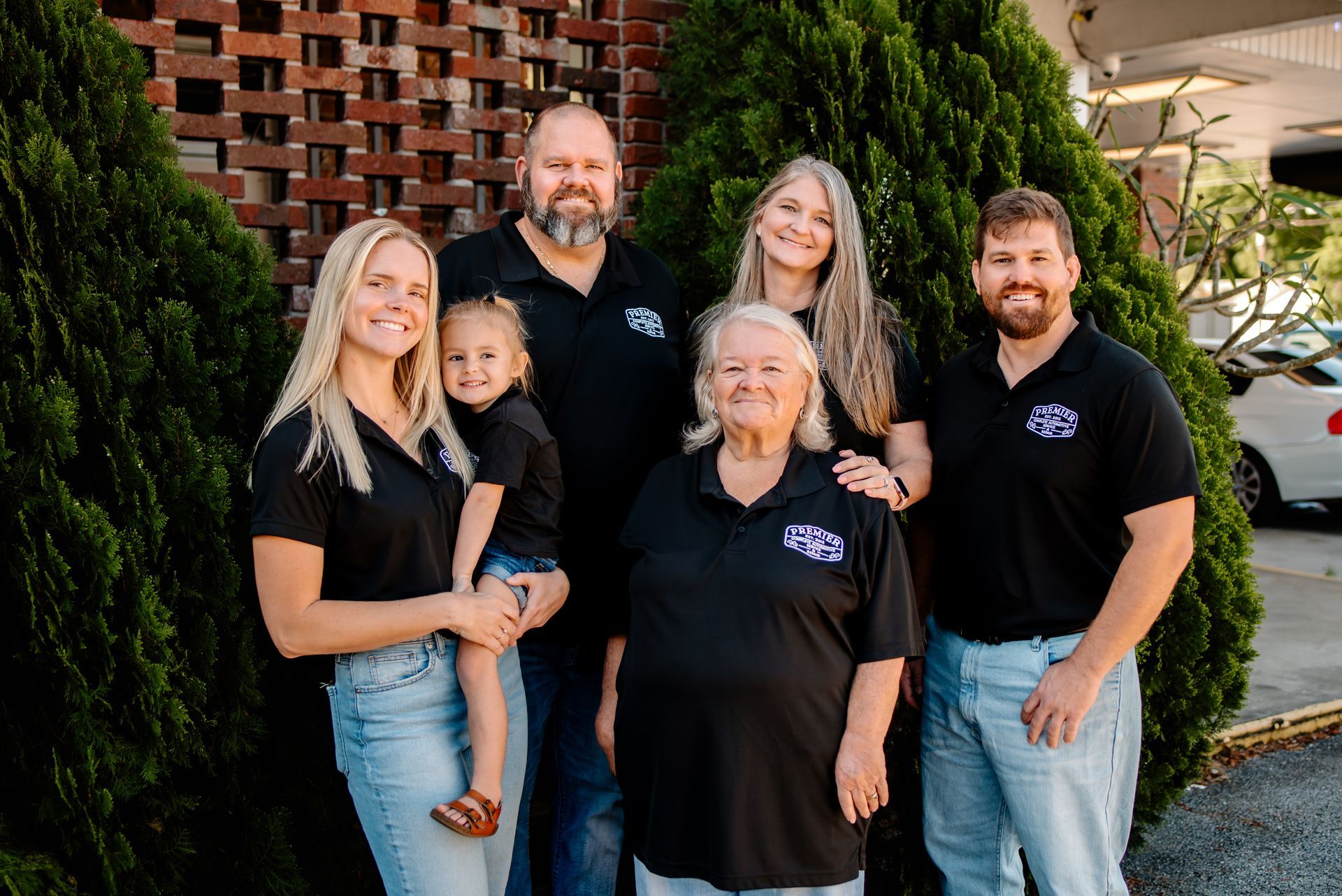 A group of people are posing for a picture in front of a building.
