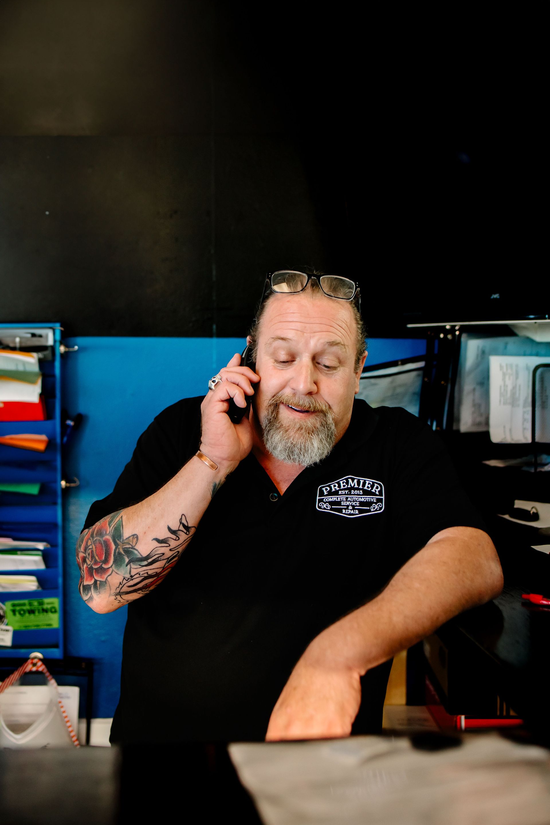 A person is taking a picture of a car with a tablet.