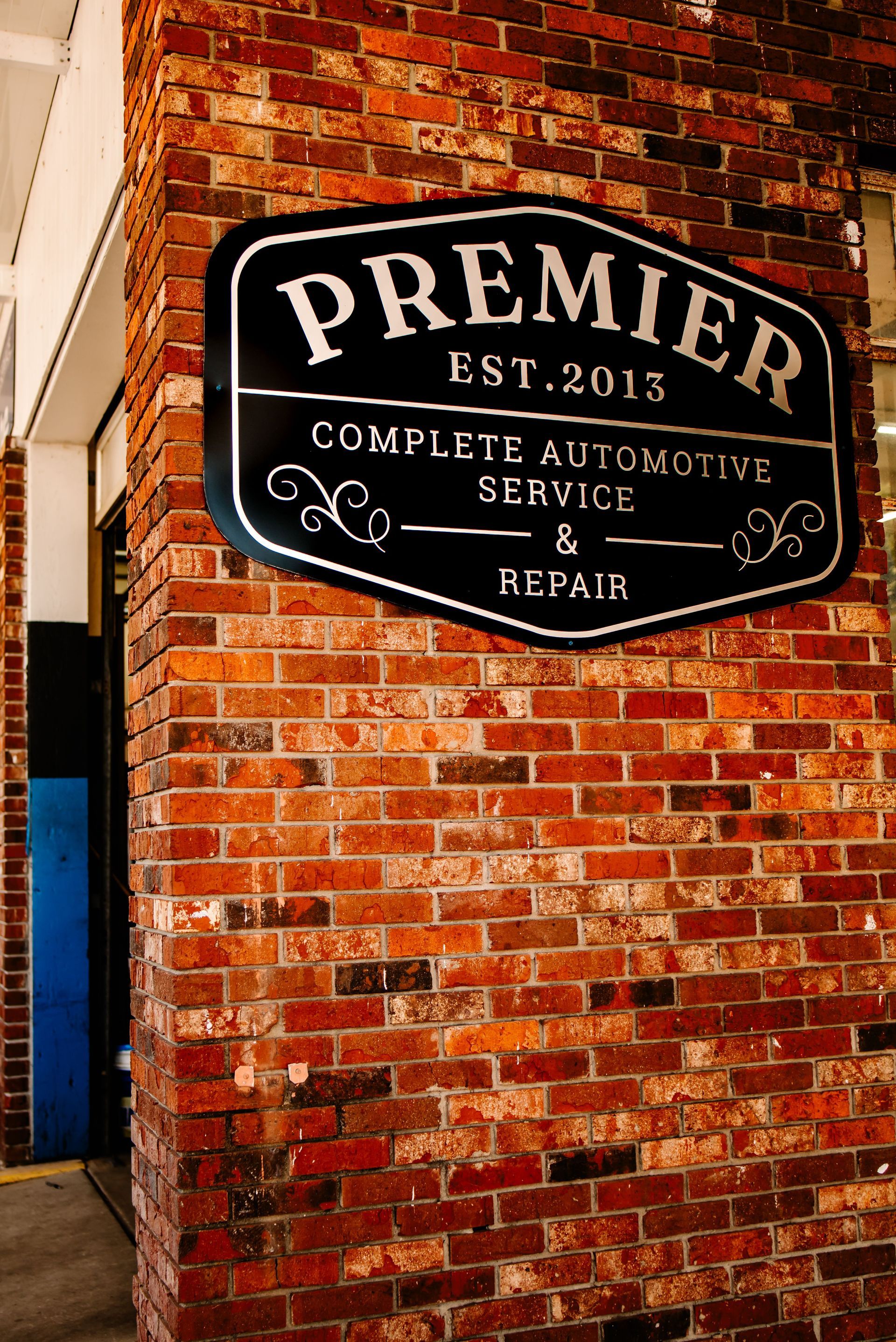 A group of people are posing for a picture in front of a brick wall.