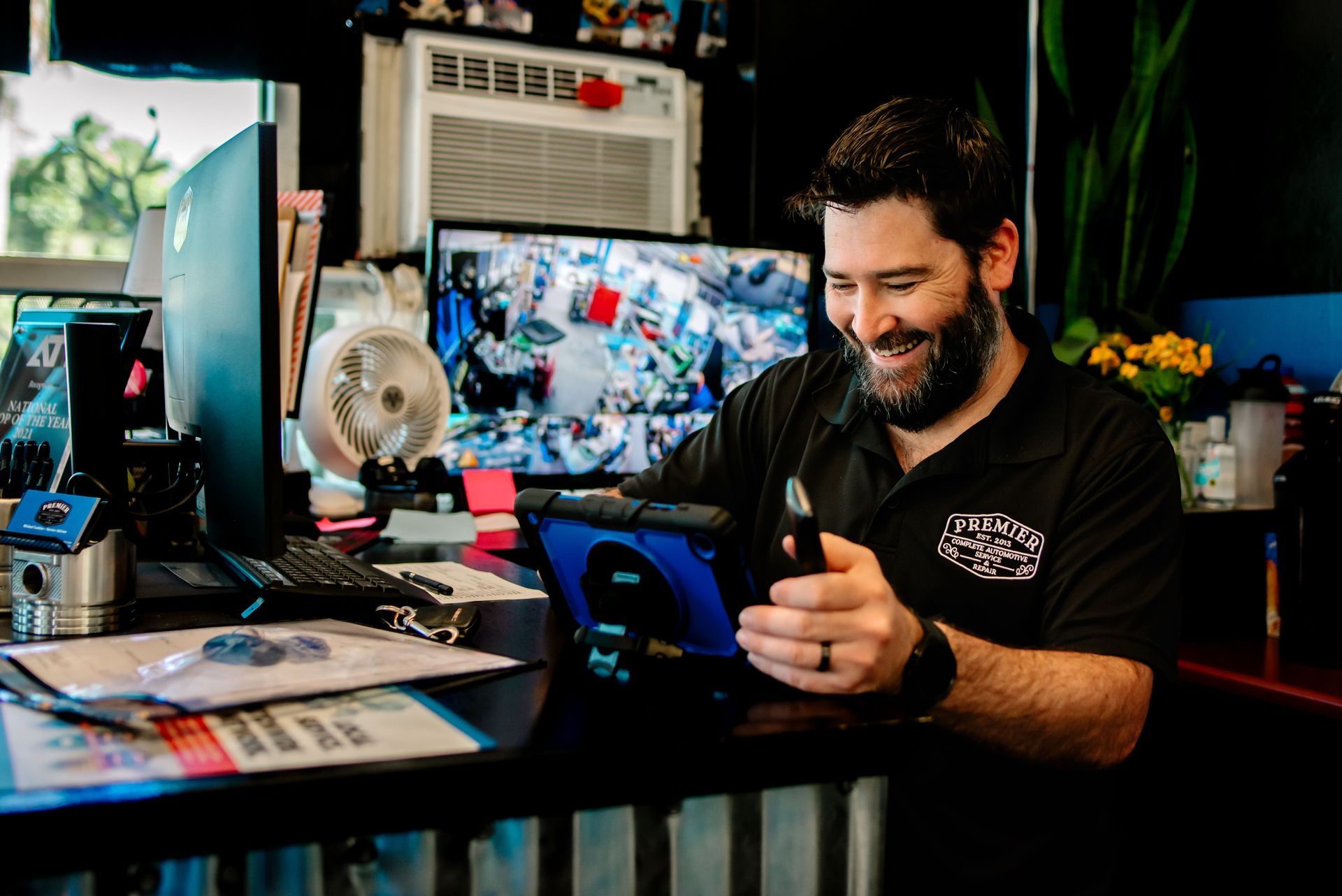 A man and a woman are standing next to each other in front of a row of signs.