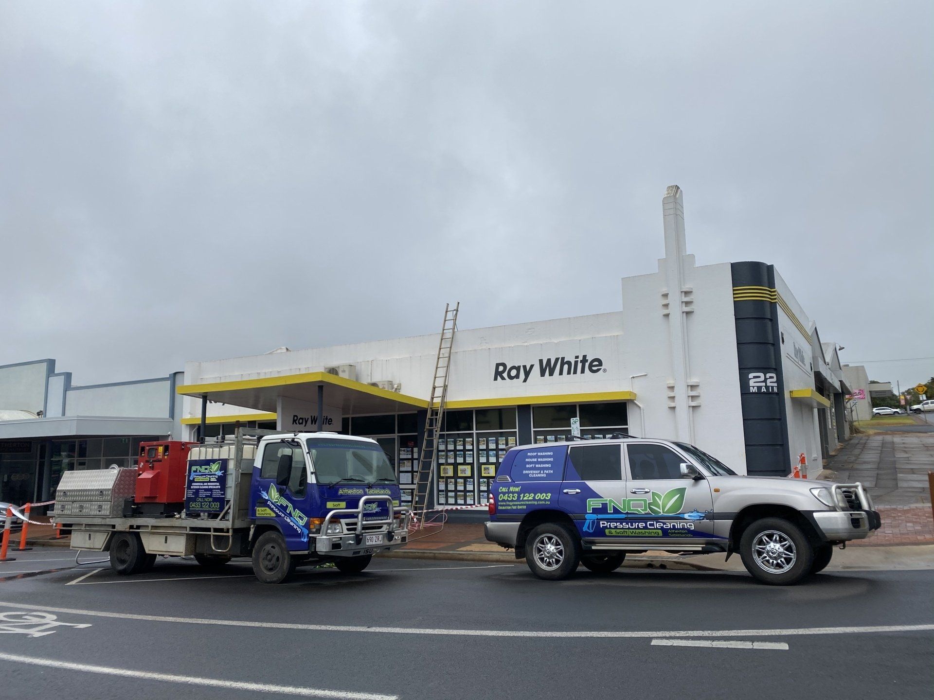 FNQ Vehicles In front Of The Ray White Building — FNQ Pressure Cleaning  in Atherton, QLD